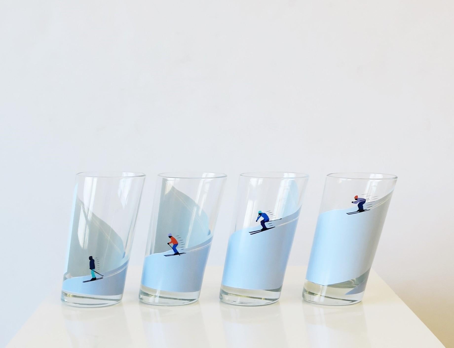 A great set of four (4) Italian highball cocktail glasses with winter alpine snow skier design. Glasses are substantial and strategically designed with an angle cut. Skier's shown on mountain in four different positions. A great set for any bar, bar