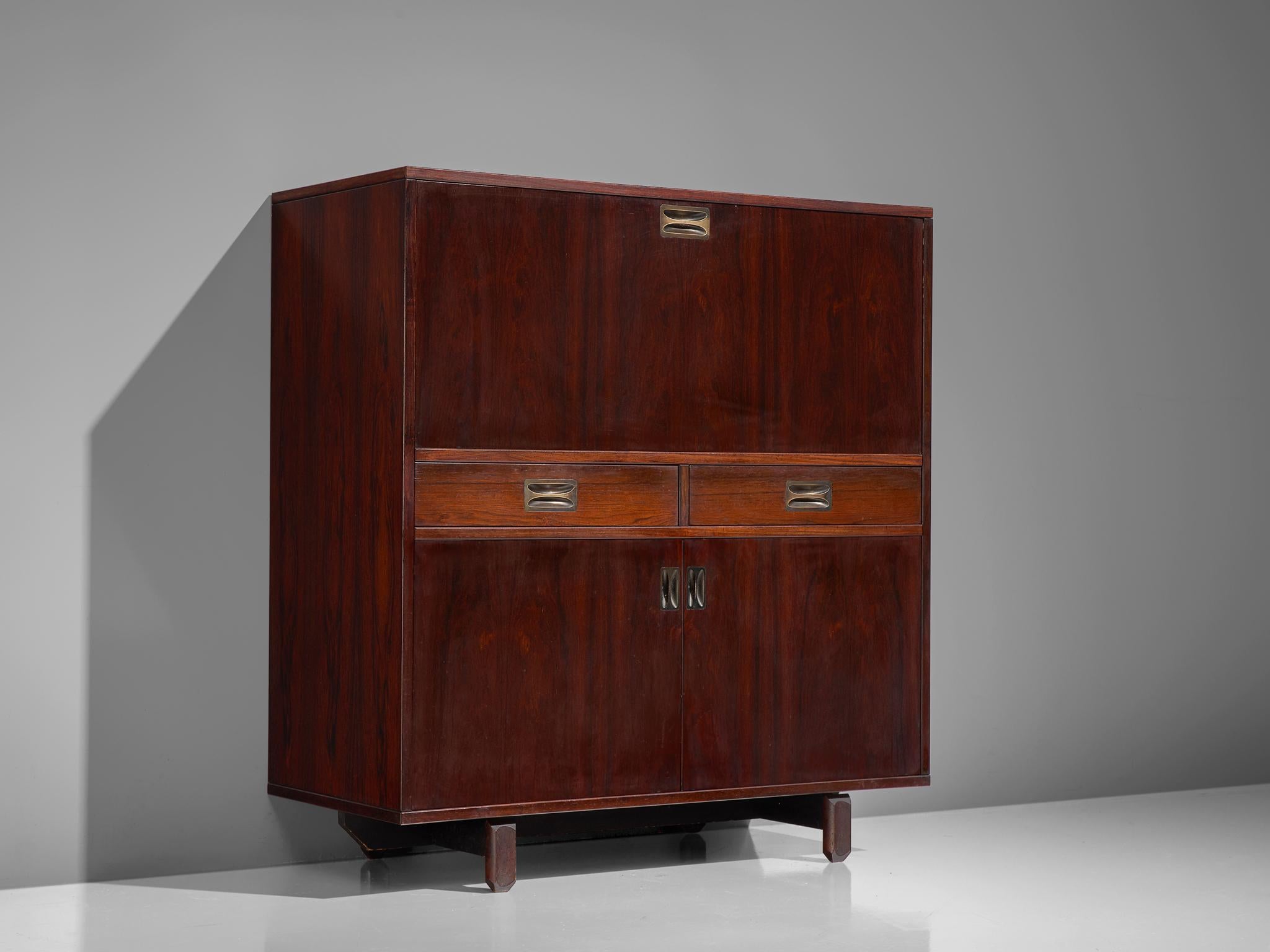 Highboard by Stildomus, rosewood, brass, Italy, 1950s

This exquisitely finished rosewood cabinet features three doors and two drawers. Remarkable are the sculpted feet lifting the board up. At the bottom two doors give access to storage. Followed