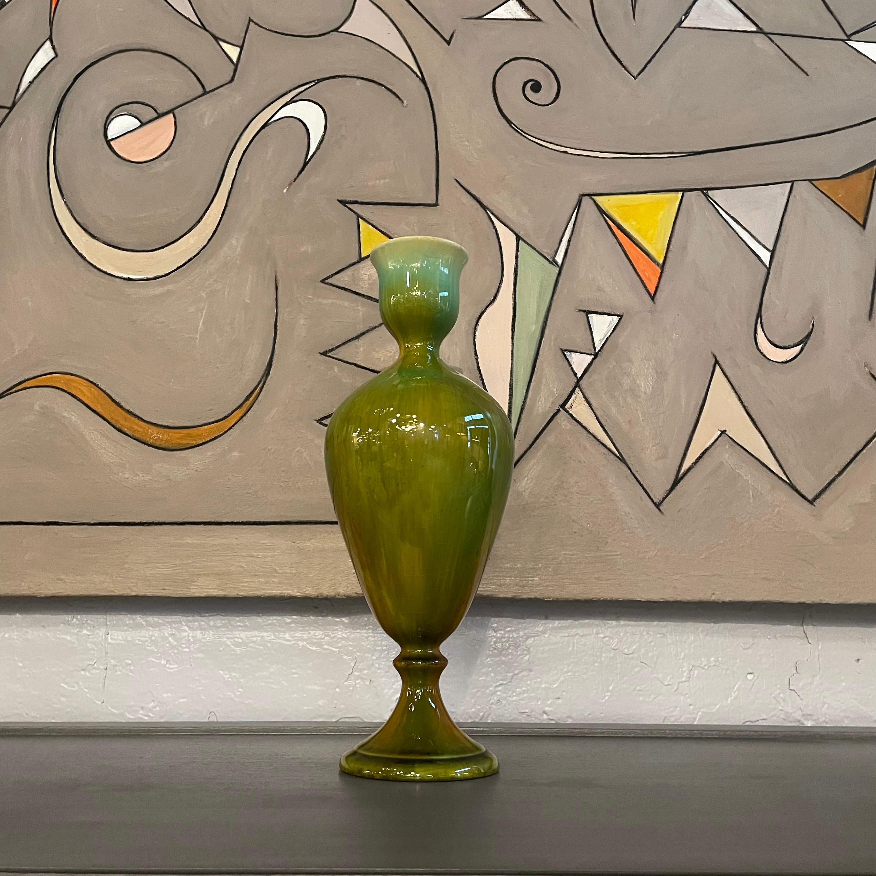 Midcentury, Hollywood Regency, art pottery vase features an urn shaped form with a variegated green high glaze.