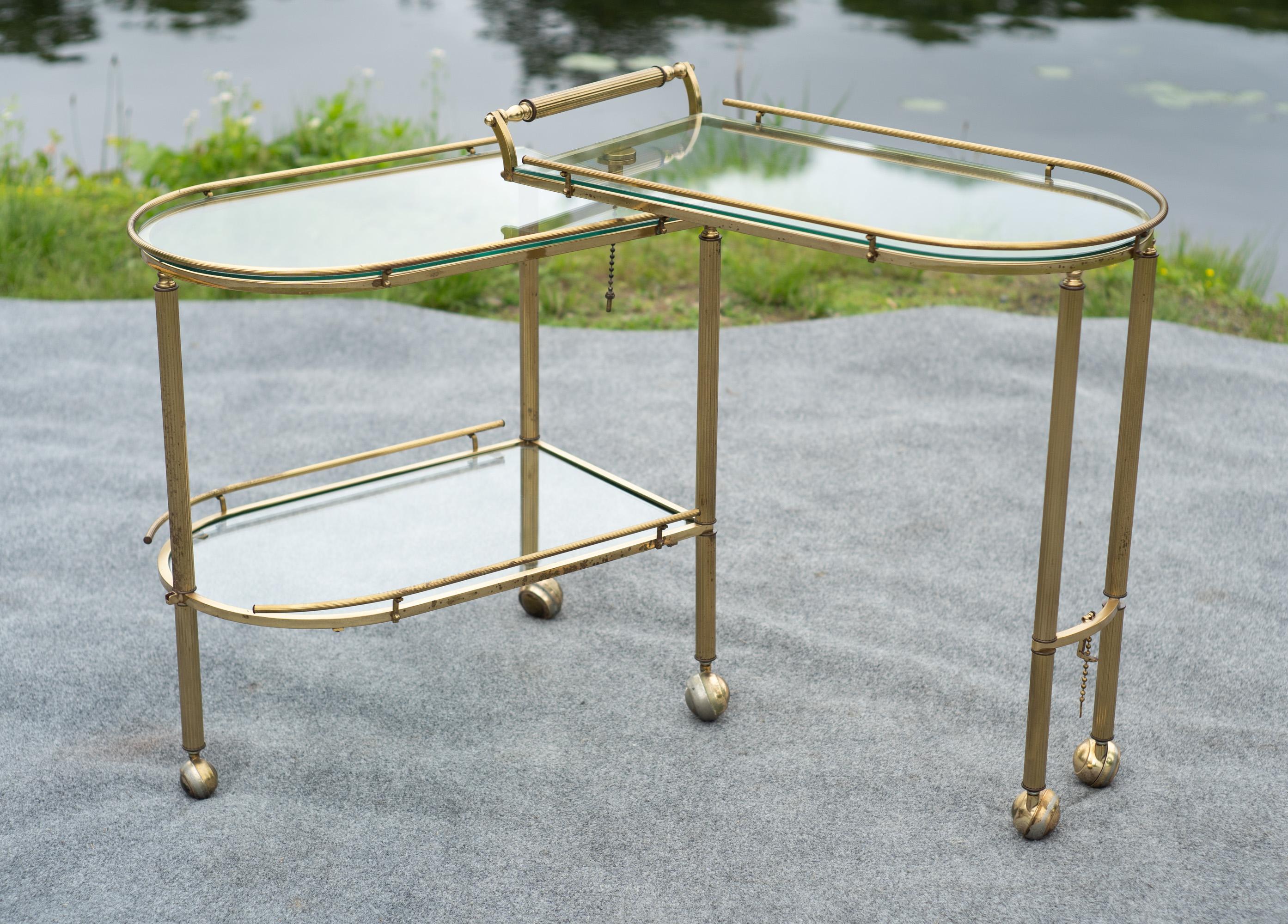 Designed and made in Italy, this three-tiered bar cart features outstanding practicality, quality, and looks. Made entirely of metal and glass, there isn't a single bit of plastic to be found on this cart. Ornate and fluted brass bars are bent and