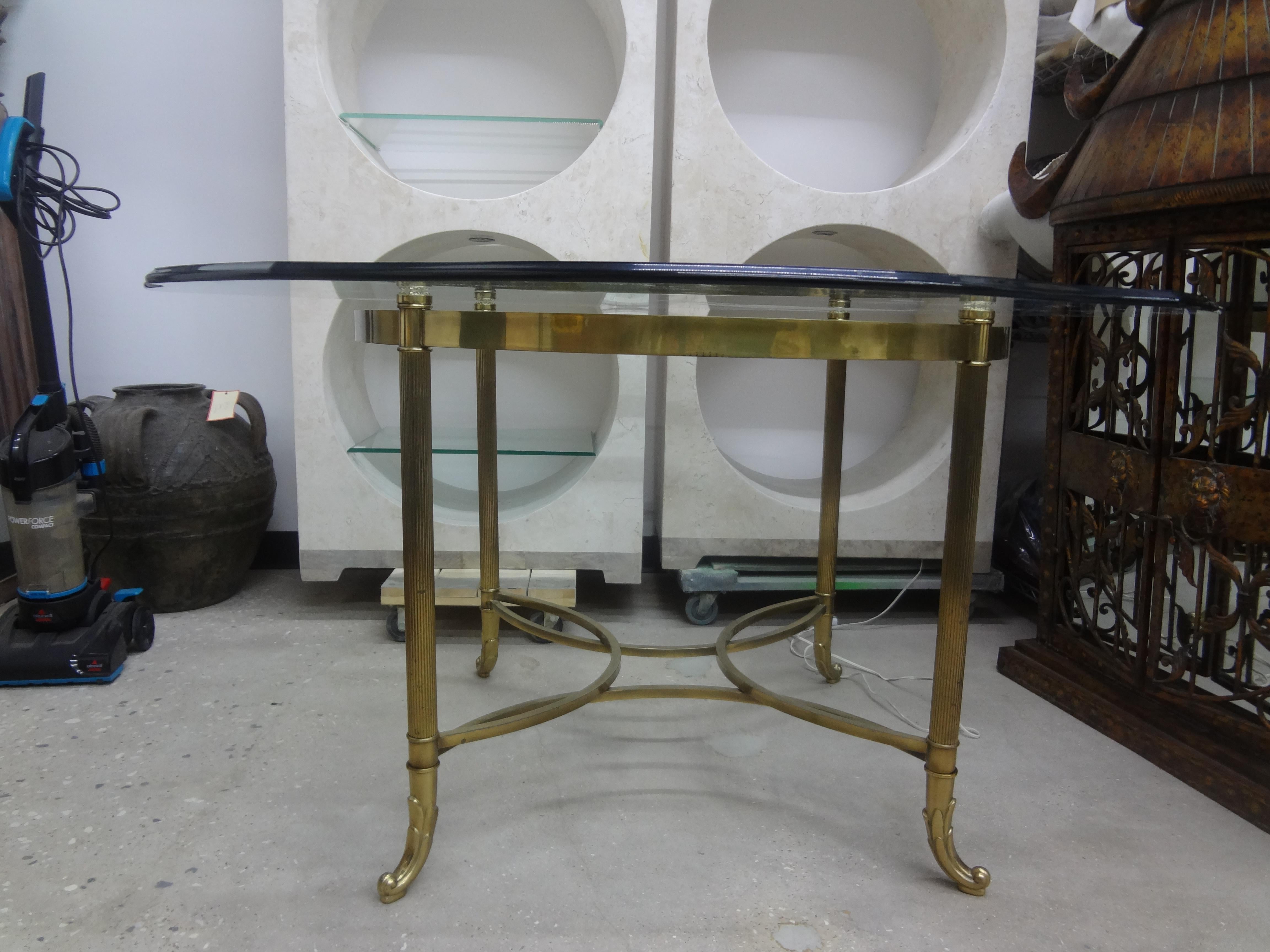 Italian Hollywood Regency Brass Center Table Or Dining Table.
This versatile vintage 54 inch Italian brass table can be used as a center table, dining table, game table or breakfast table. It retains the beautiful original scalloped glass
