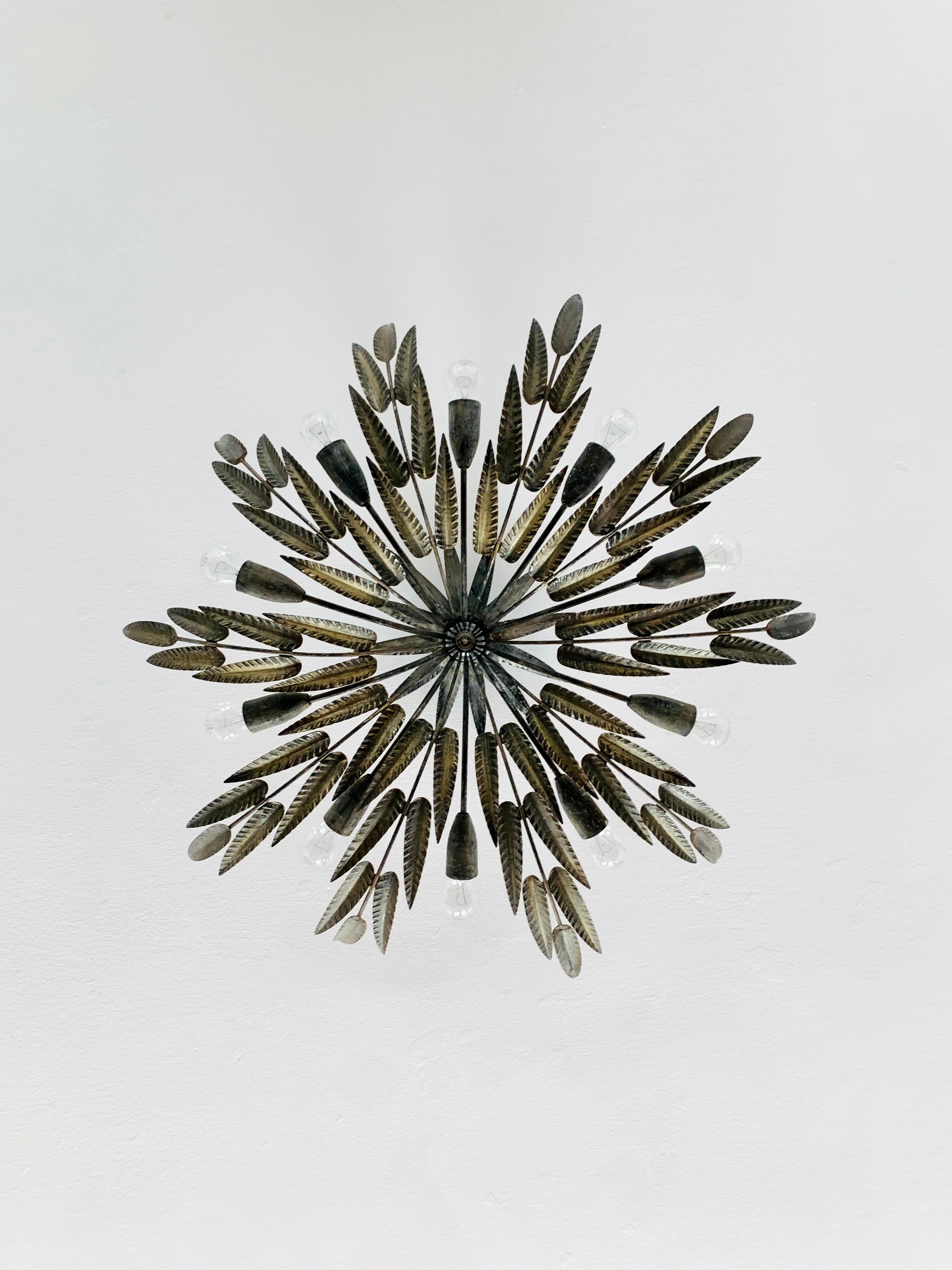 Exceptionally decorative brutalist ceiling lamp from the 1970s.
Great design and high-quality workmanship.
The leaves create a great, very noble light.

Condition:

Very good vintage condition with slight signs of wear consistent with