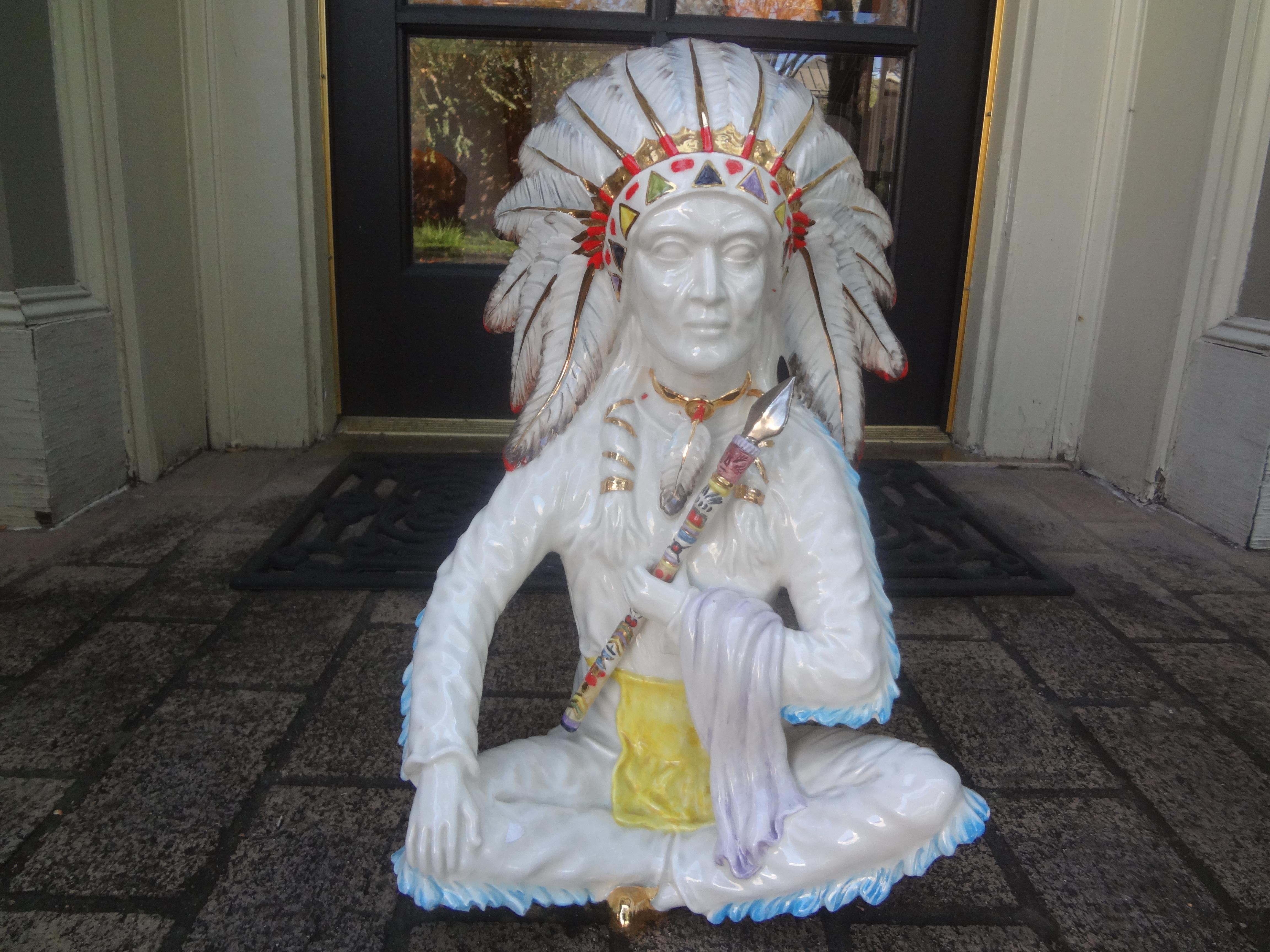 Italian Hollywood Regency Ceramic Indian Chief.
This interesting vintage Italian ceramic sculpture or figure depicts an Indian chief with a beautiful headdress in a seated position.