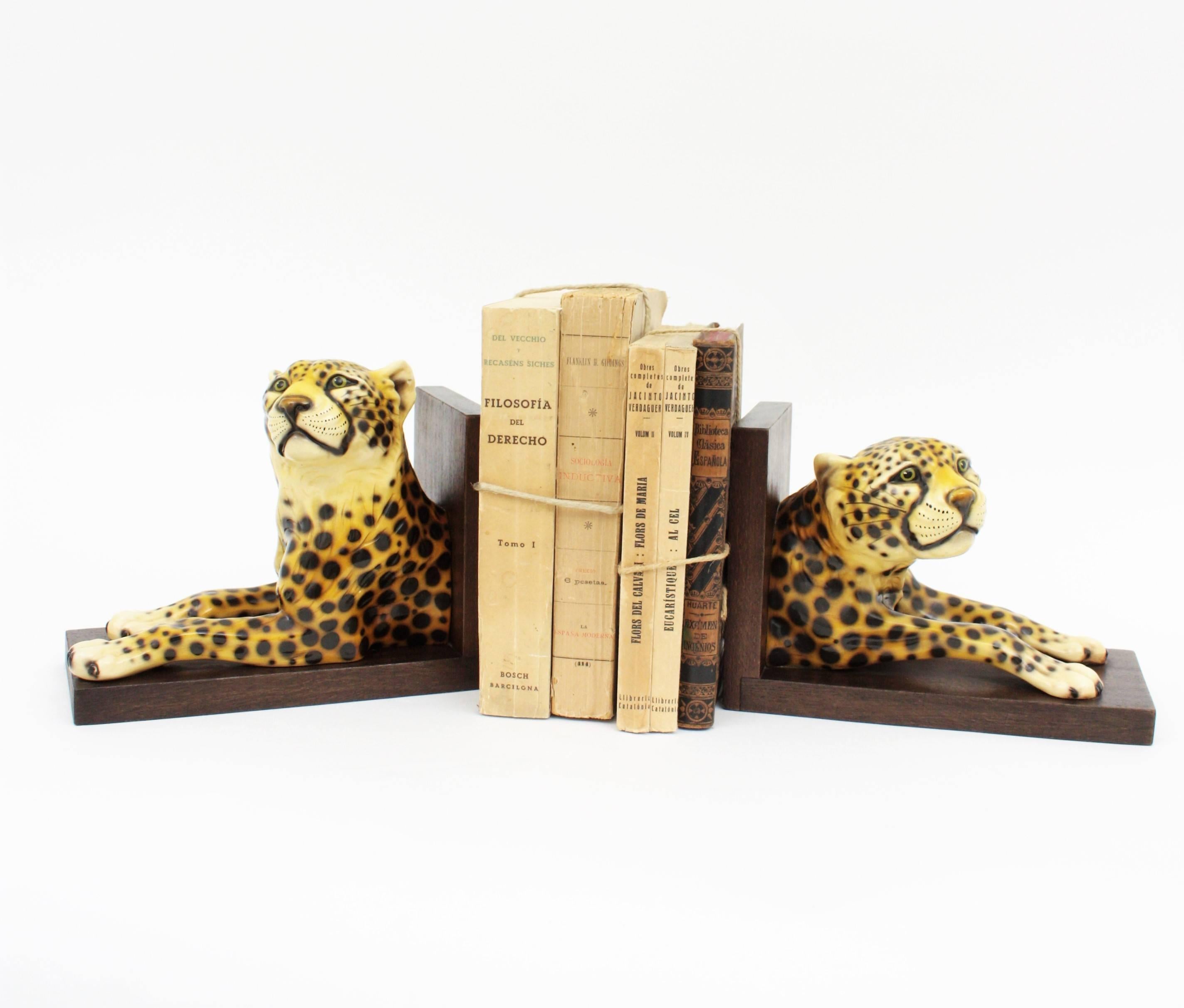 Pair of highly decorative hand painted ceramic cheetah bookends on wooden bases. Italy, 1950-1960.
Each bookend has a very realistic cheetah figure in different position.
This pair of book holders would be an interesting Midcentury accent in any