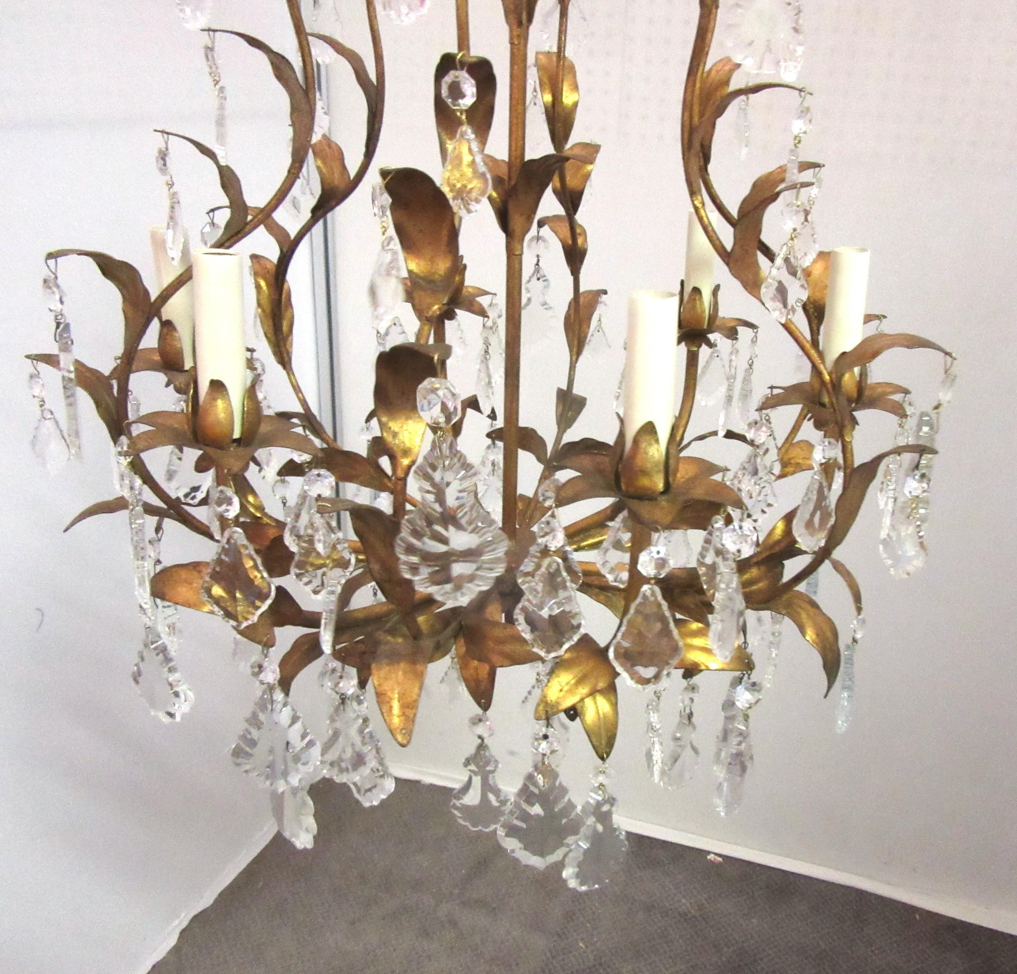 Italian Hollywood Regency Florentine bird cage chandelier made in Italy during the 1950s. The piece comes with graduated crystals and six lights. Restored with new light sleeves and antique crystals. Dimensions: 21