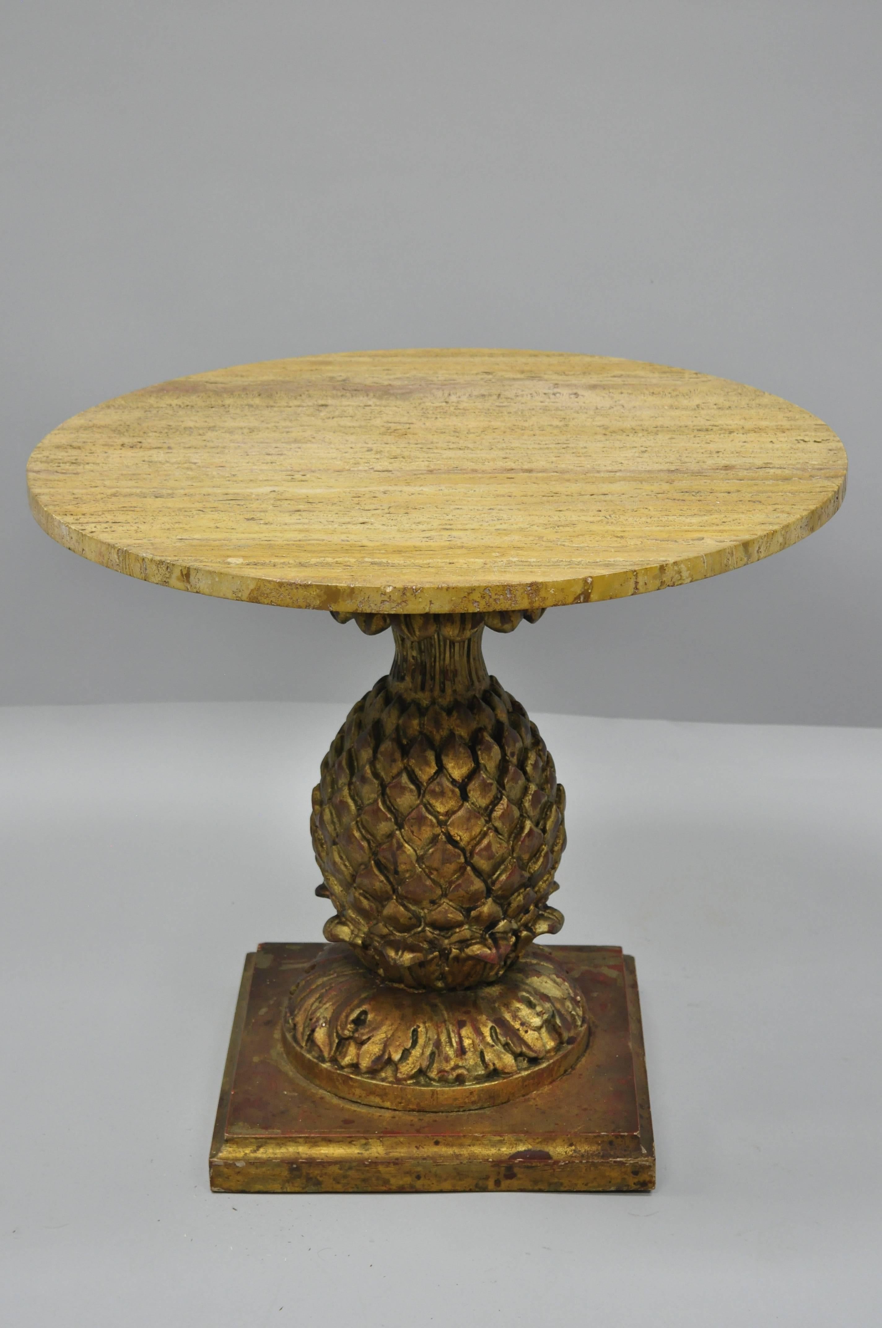 Vintage Italian Hollywood Regency giltwood carved pineapple travertine top side table. Item features hand-carved giltwood pineapple base, round travertine top, gold and red distressed painted finish, circa mid-20th century. Measurements 21