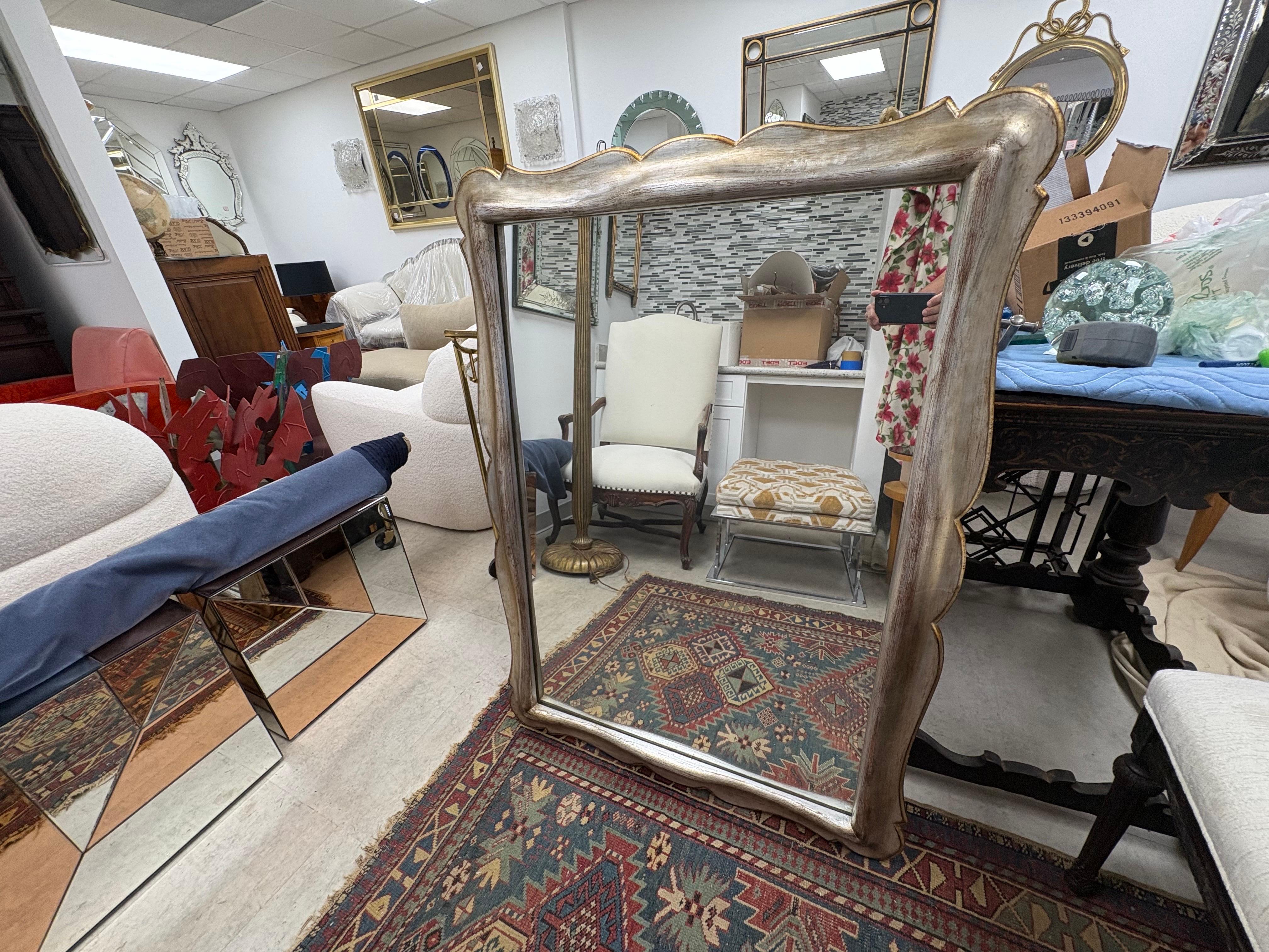 Italian Hollywood Regency Giltwood Mirror.
Offered is a sculptural Italian mid century silver gilt mirror accented in gold gilt.
This versatile Italian Hollywood Regency mirror would work in many rooms including entrance hall, powder room, bedroom