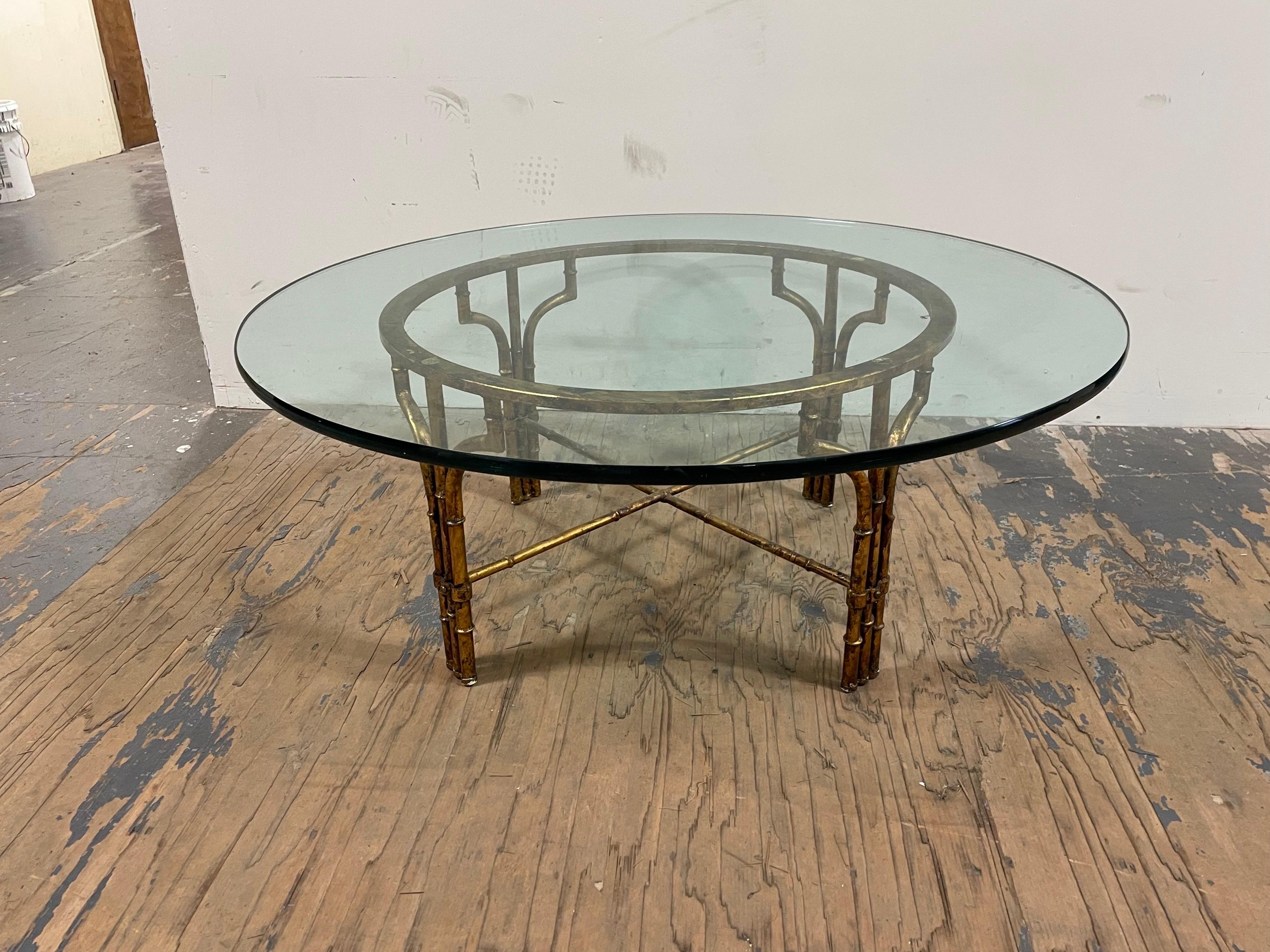 Gilt bamboo and glass coffee table. Thick circular glass. Timeless lines and design for versatility.