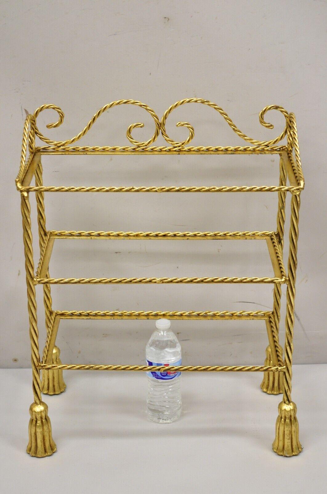 Vintage Italian Hollywood Regency Gold Gilt Iron 3 Tier Shelf Small Curio Display stand (B). Item featured is a nice small Size, 3 tiers, (no glass for shelves), rope design frame, tassel form feet, wrought iron construction, quality Italian