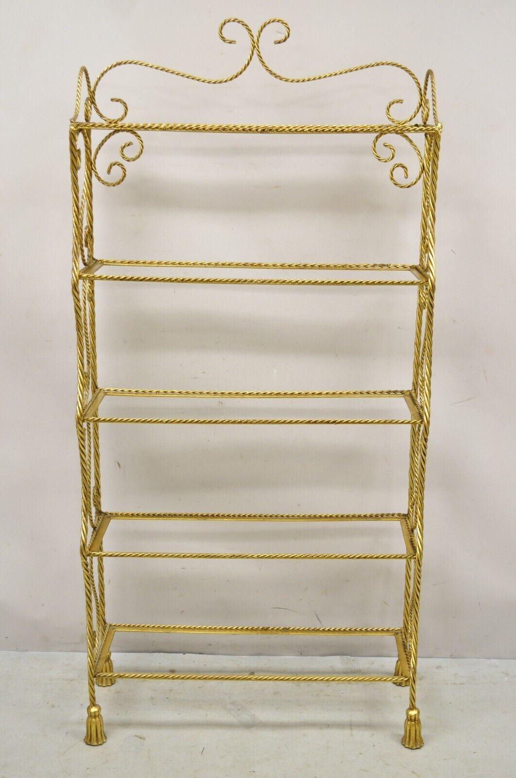 Italian Hollywood Regency Gold Gilt Iron 5 Tier Rope Tassel Etagere Shelf Stand. Item features a gold gilt iron frame, rope design with tassel feet, 5 tiers (no glass shelves), wrought iron construction, very nice vintage item, quality Italian