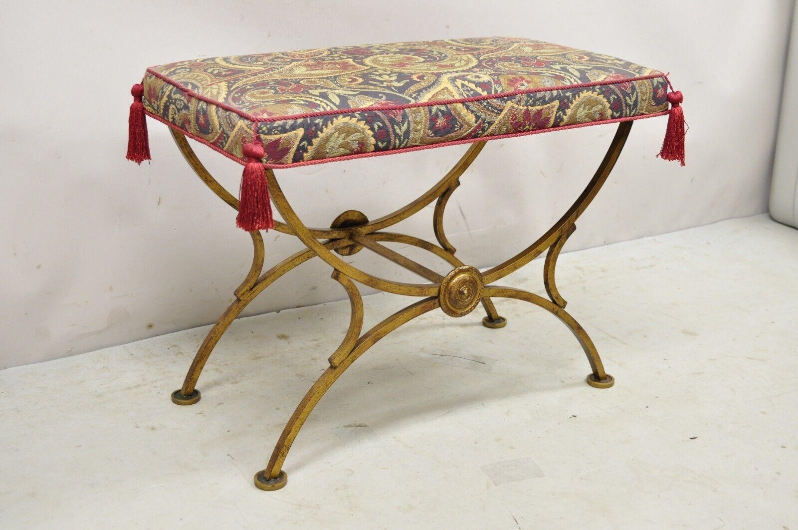 Vintage Italian Hollywood Regency gold gilt iron curule x-form vanity bench seat stool. Item features an X-frame, gold finish, upholstered seat with tassels, wrought iron construction, very nice vintage item, great style and form. Circa Mid 20th