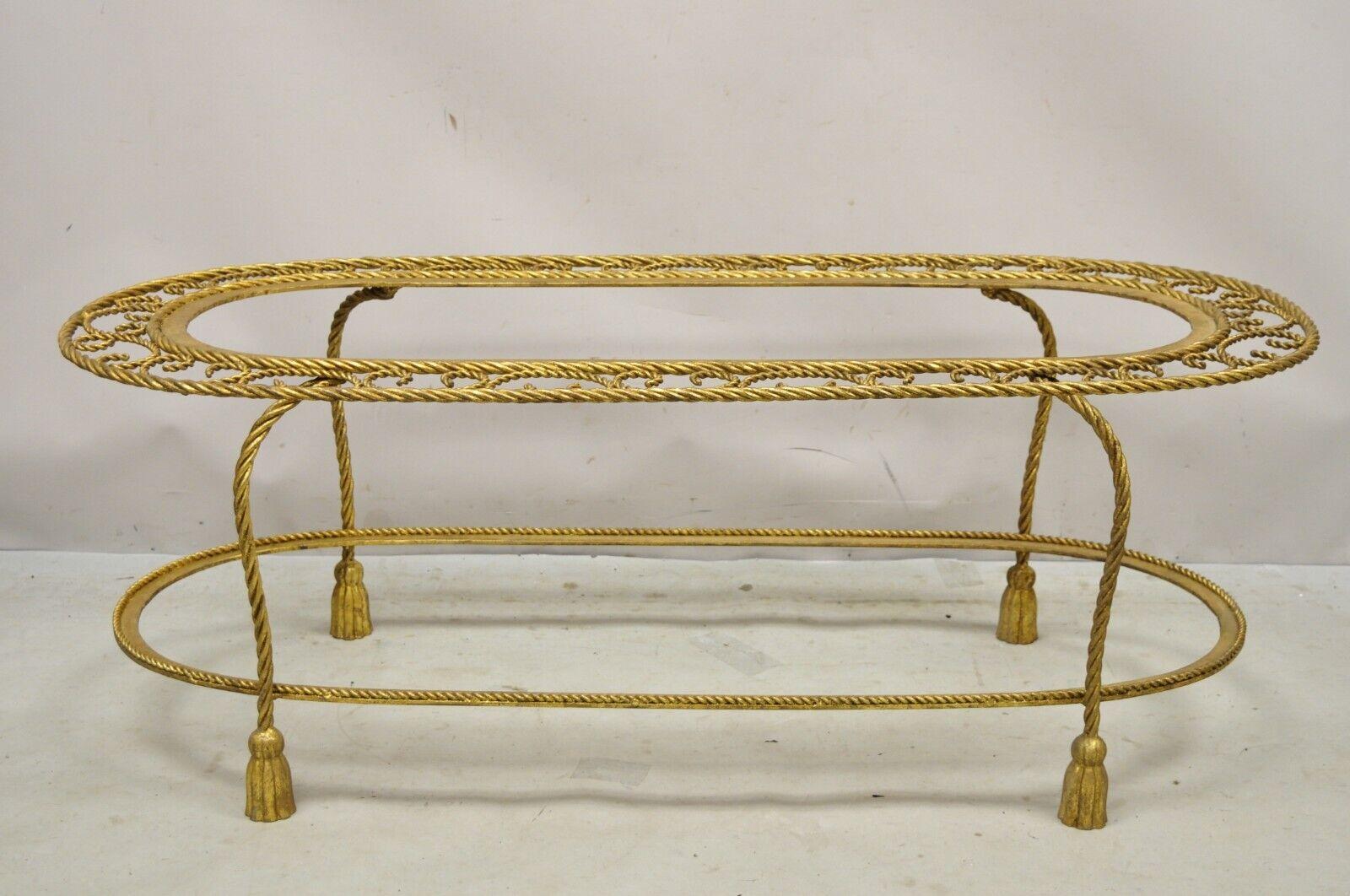 Vintage Italian Hollywood Regency Gold Gilt Iron Oval 2 Tier Rope Tassel Coffee Table. Item features 2 tiers (does not include glass tops), nice oval form, wrought iron rope form frame with tassel fee, very nice vintage item, great style and form,