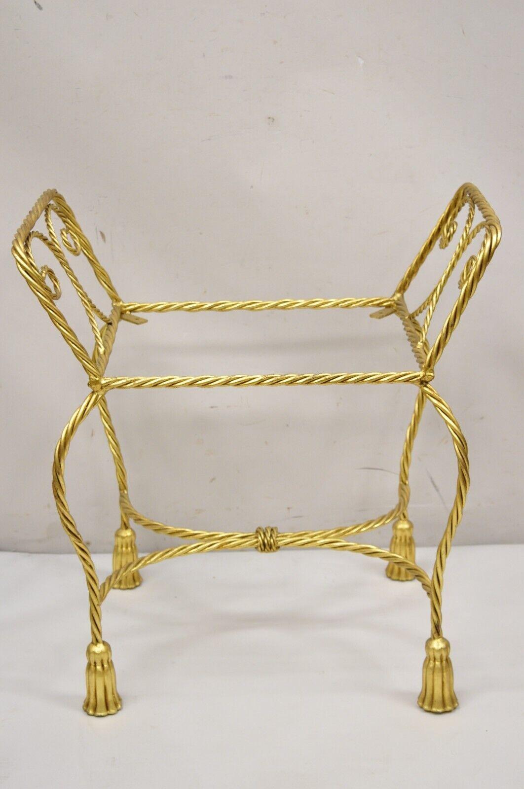 Vintage Italian Hollywood Regency Gold Gilt Iron Rope Tassel Form Vanity Bench Chair Seat. Item features tassel form feet, iron metal scrolling rope frame, gold leaf gilt finish, quality Italian craftsmanship, great style and form, does not include