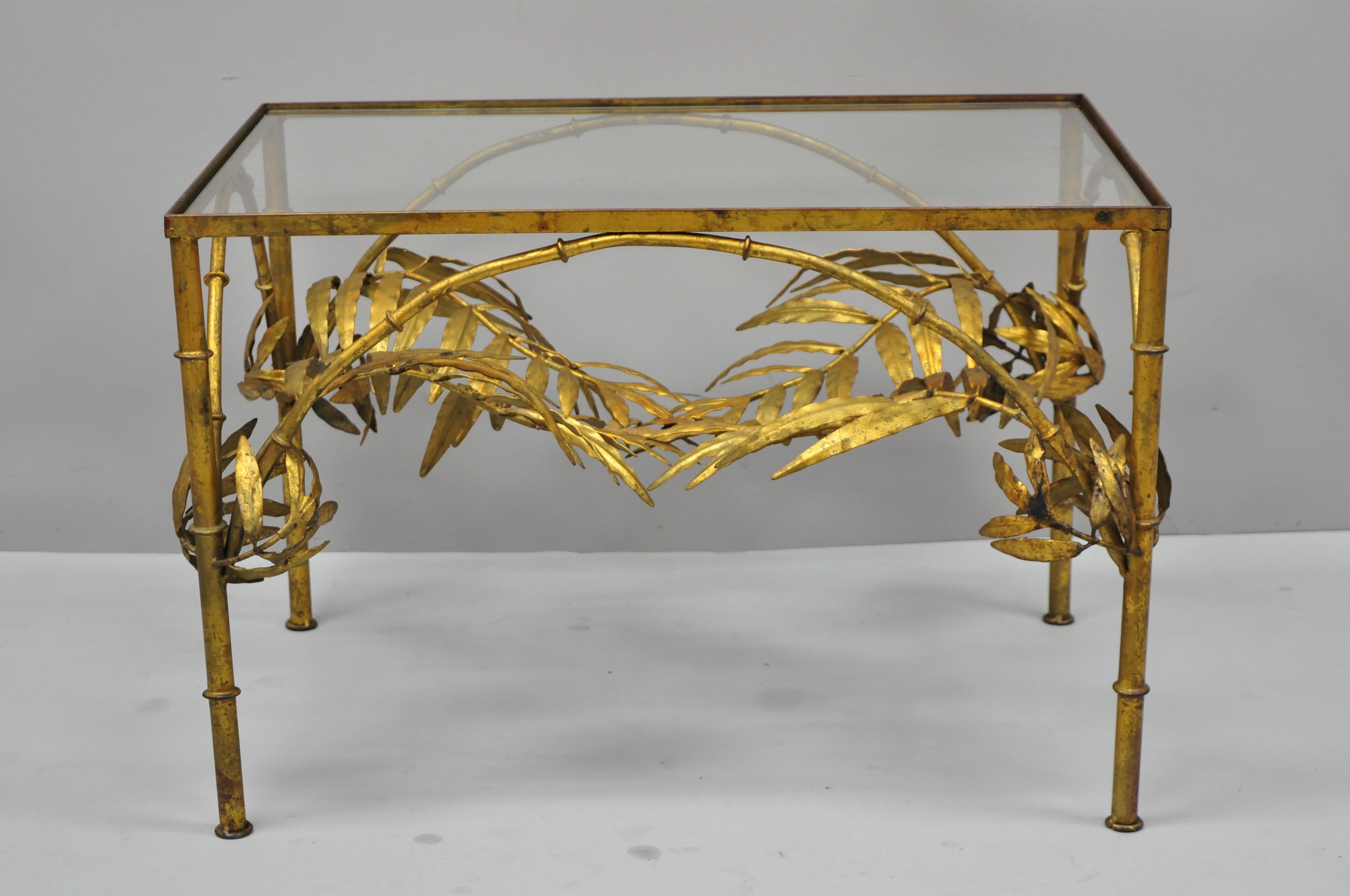 Vintage Italian Hollywood Regency gold gilt metal palm leaf iron glass top side table. Item features gold gilt metal iron frame, palm leaf centre, inset glass top, small coffee table form, very nice vintage item, quality Italian craftsmanship, circa