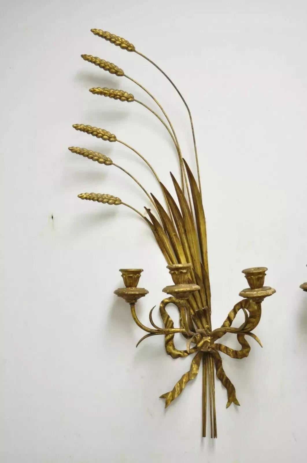 Vintage Italian Hollywood Regency Gold Wrought Iron Sheaf of Wheat Candle Wall Sconces - a Pair. Item features (3) carved wood candleholders per sconce, iron frames, bow and wheat sheaf details, left and right forms, very nice vintage pair. Circa