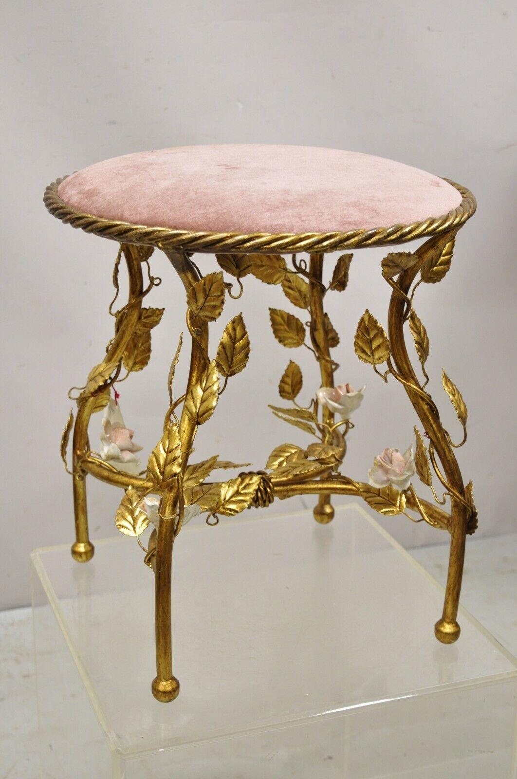 Vintage Italian Hollywood Regency Iron Metal Rope Gold Leaf Gilt Pink Seat Vanity Bench Stool. Item features pink porcelain flower accents to base, gold leaf gilt finish, iron frame, rope form seat, original label, very nice vintage item, quality