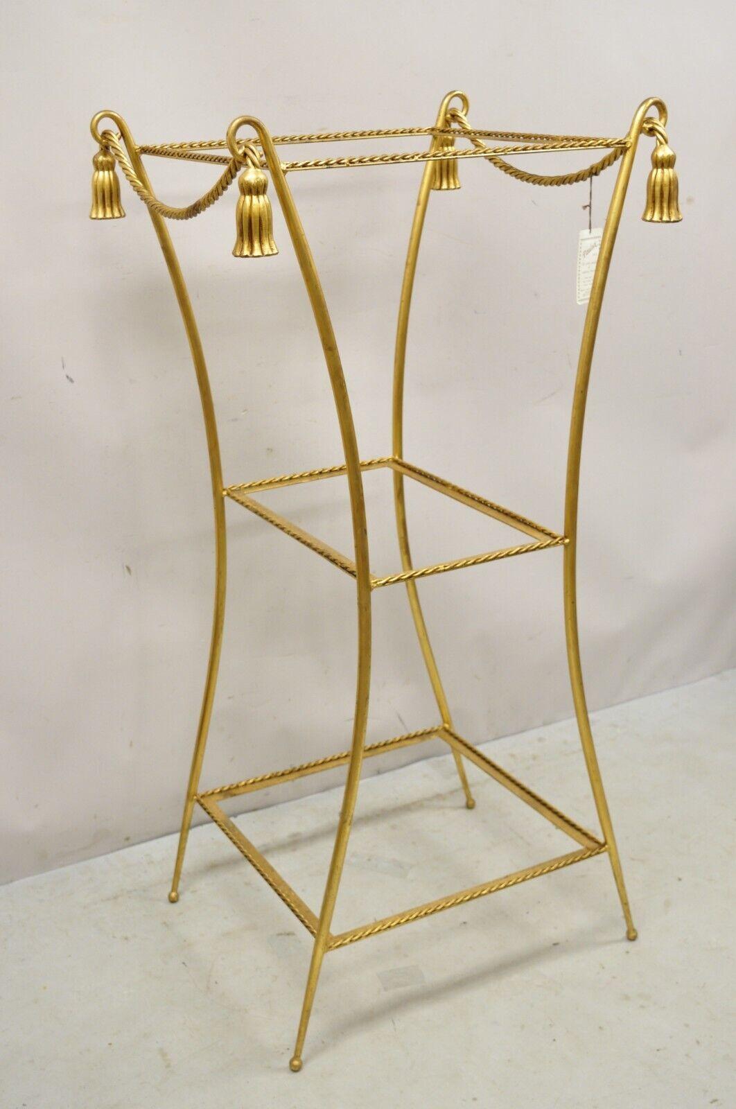 Vintage Italian Hollywood Regency Iron Rope Tassel Gold 3 Tier Display Curio stand Pedestal. Item features tassel and rope form accents, gold gilt leaf finish, 3 tiers (no glass), wrought iron construction, very nice vintage item, quality Italian