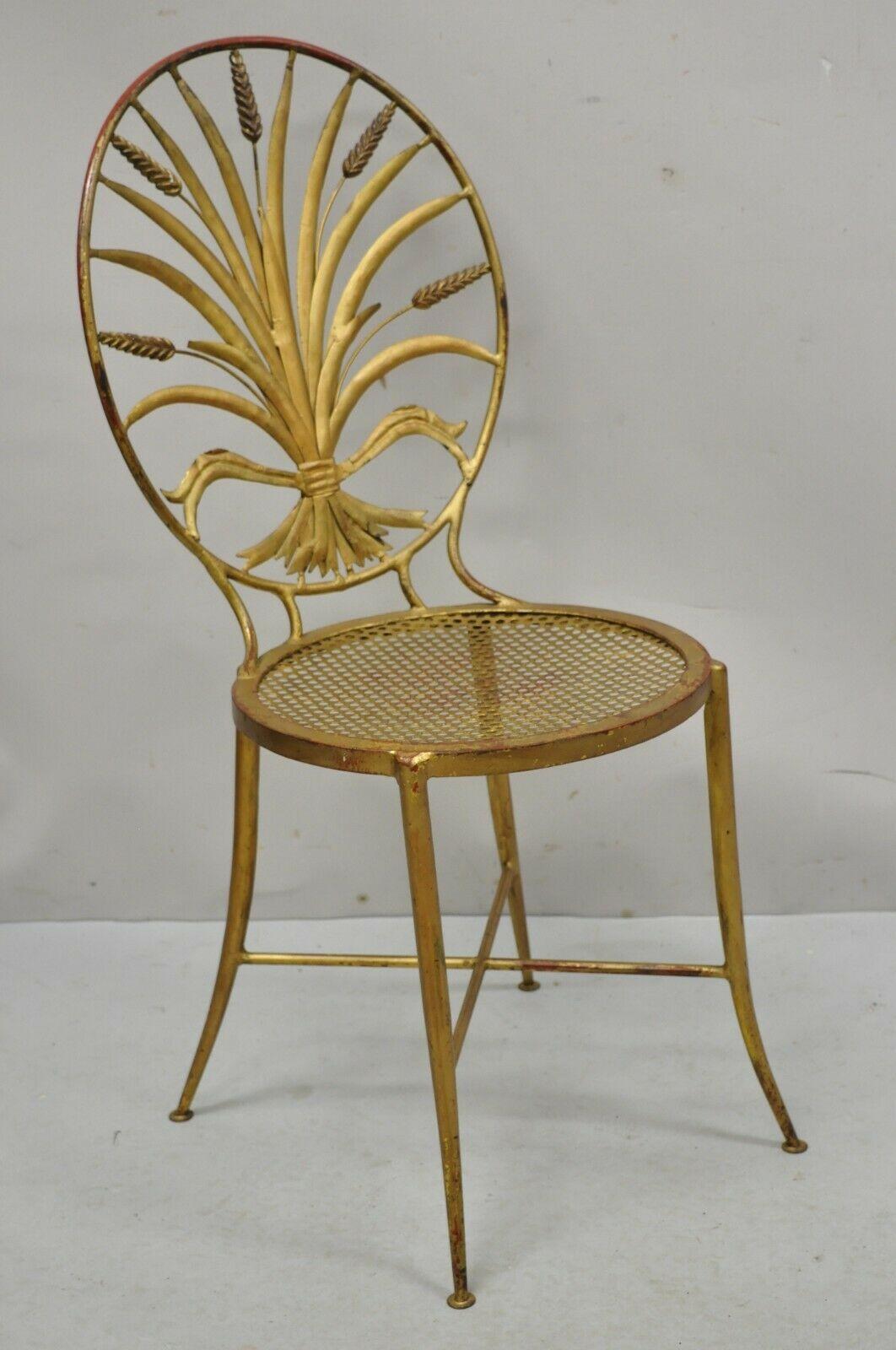 Italian Hollywood Regency iron tole metal gold gilt wheat sheaf Salvador side chair. Item features an oval back with sheaf of wheat design, cross stretcher base, wrought iron construction, gold gilt distressed finish, tapered legs, very nice vintage