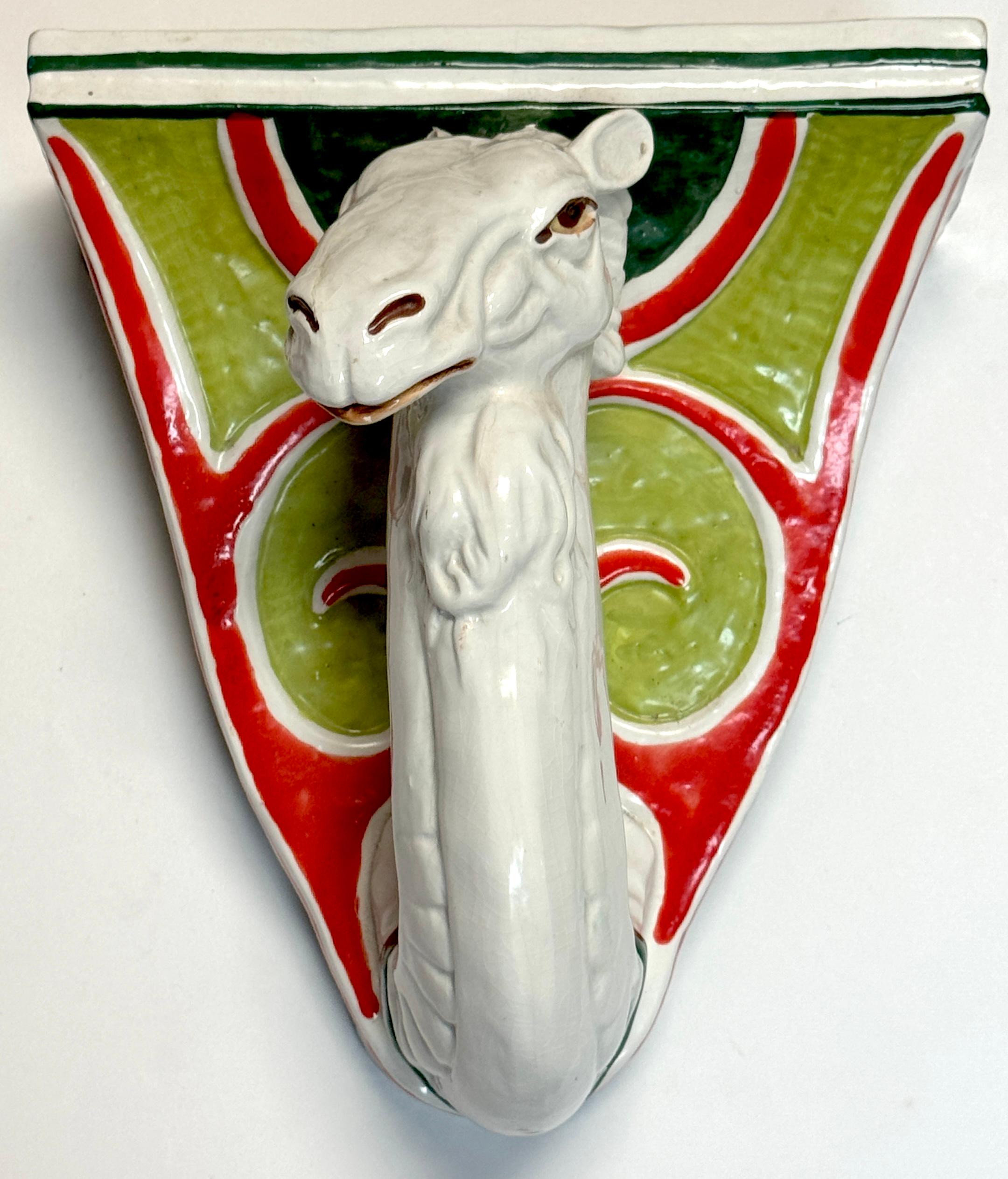 Italian Hollywood Regency Majolica Camel Head Wall Bracket / Shelf, Circa 1970s, Stamped Italy

A striking and whimsical example of Italian mid-20th century majolica, this sculptural wall bracket takes the form of an elongated camel head emerging