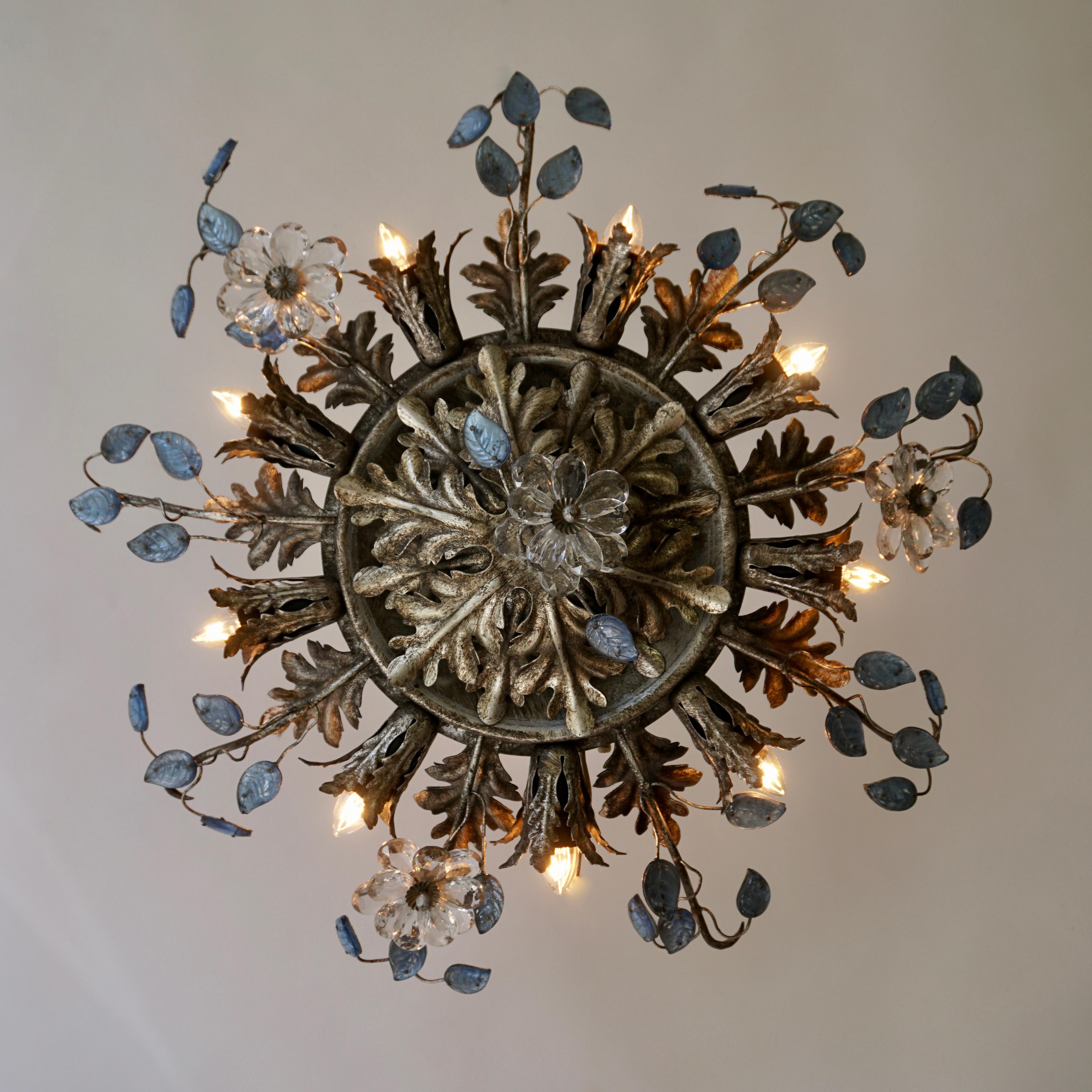 Beautiful flush mount fixture which can be used also as wall sconce - this Italian light with metals leaves, small blue glass leaves and transparent flowers is gorgeous! The light fixture has 9-light bulb holders spread around as a sunburst. With