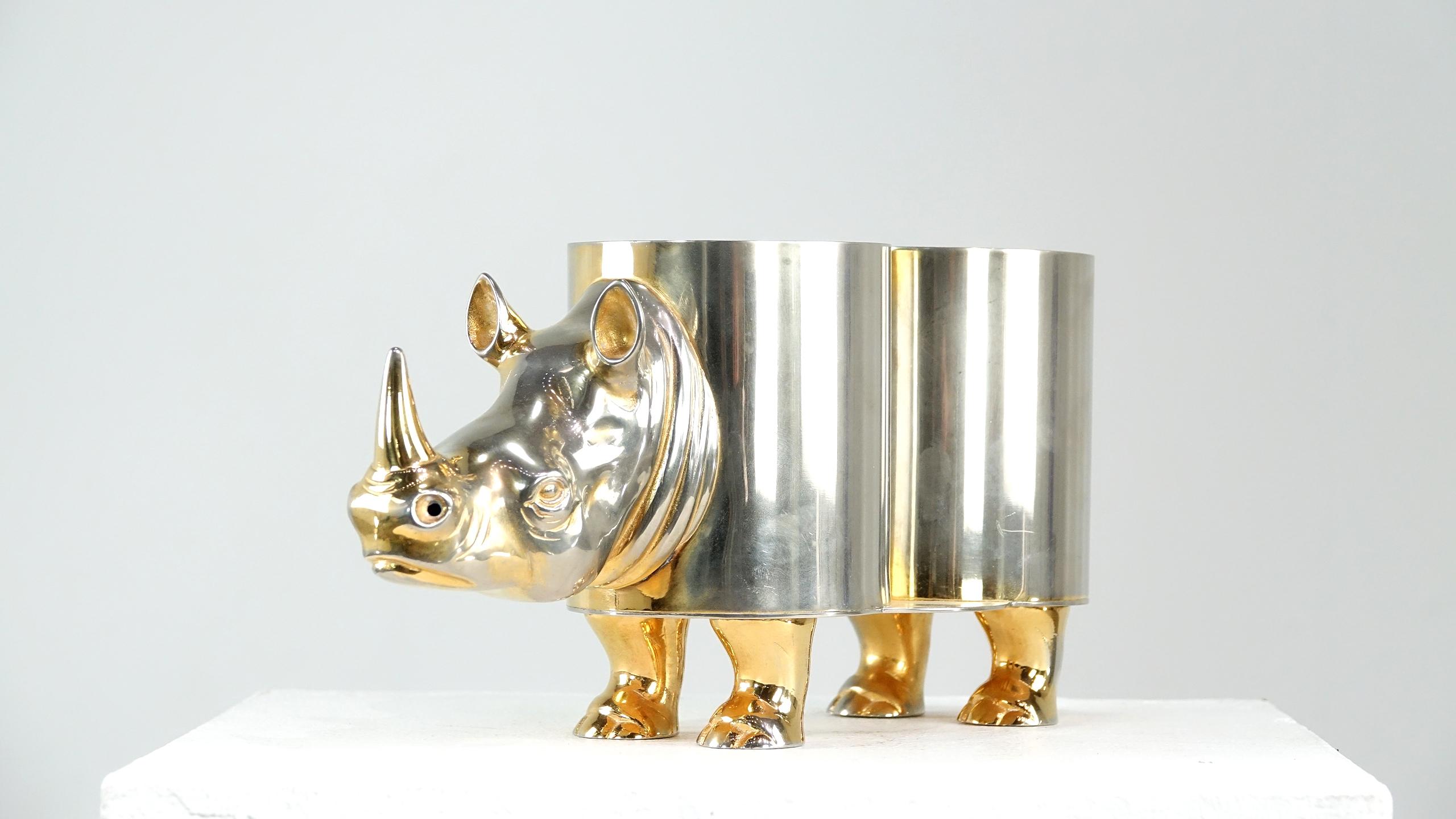 Fabulous and rare Italian Hollywood Regency rhinoceros double wine bottle holder.
Two colors to the brass, head and feet have a gold tone the rest of the body is nickel on brass.