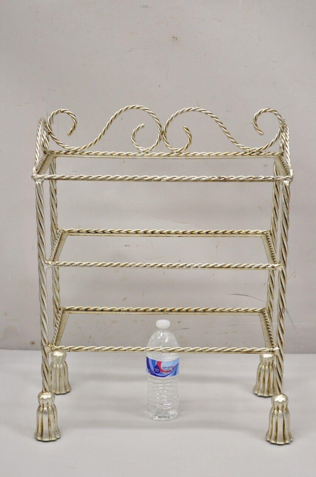 Vintage Italian Hollywood Regency Silver Leaf Gilt Iron 3 Tier Shelf Small Display Stand. Item featured is a nice small size, 3 tiers (no glass for shelves), rope design frame, tassel form feet, quality Italian craftsmanship, great style and form.