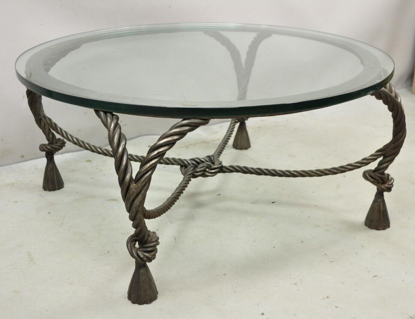 Italian Hollywood Regency Steel Knotted Rope and Tassel Round Glass Coffee Table. Item features a heavy high quality steel metal frame, knotted rope and tassel design, thick round glass top, stamped 