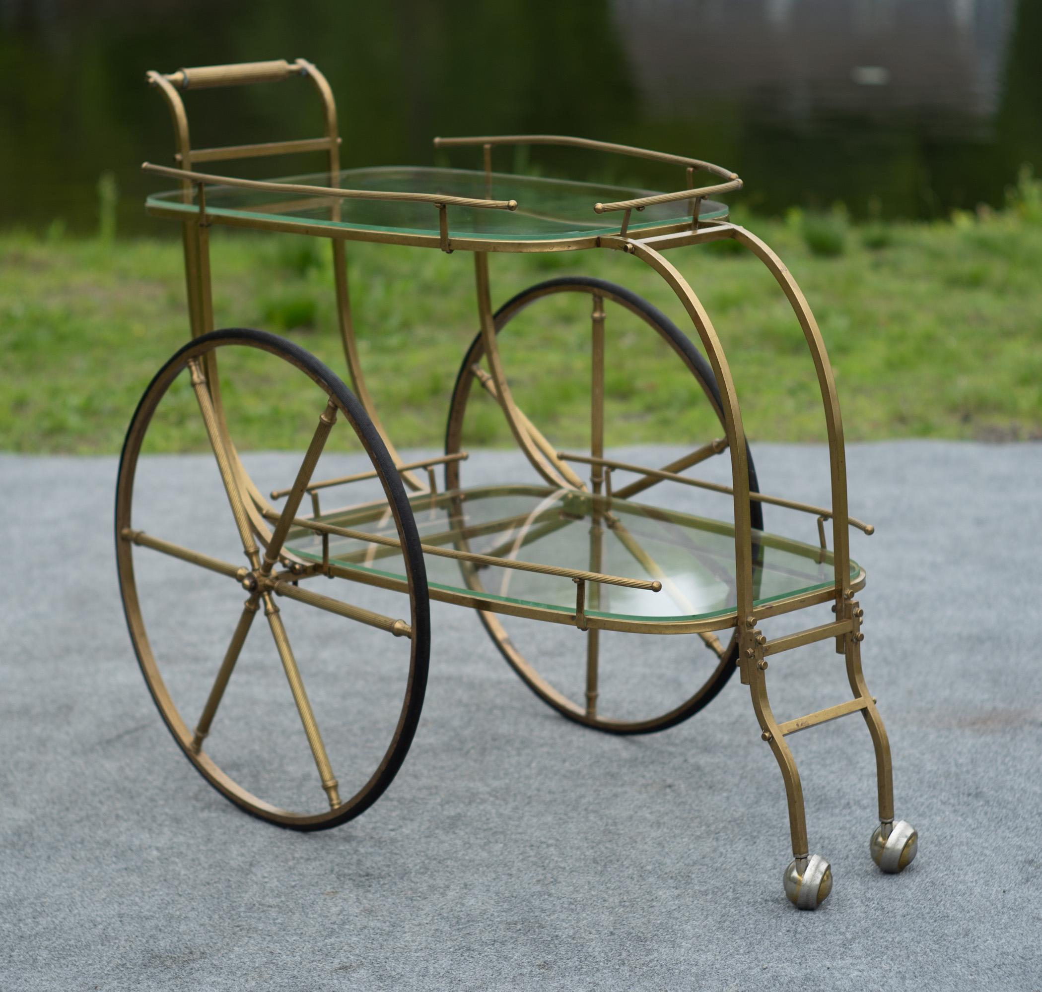 Designed and made in Italy, this two-tiered bar cart features outstanding practicality, quality, and looks. Made entirely of metal and rubber, there isn't a single bit of plastic to be found on this cart. Square brass bars are bent and shaped to the