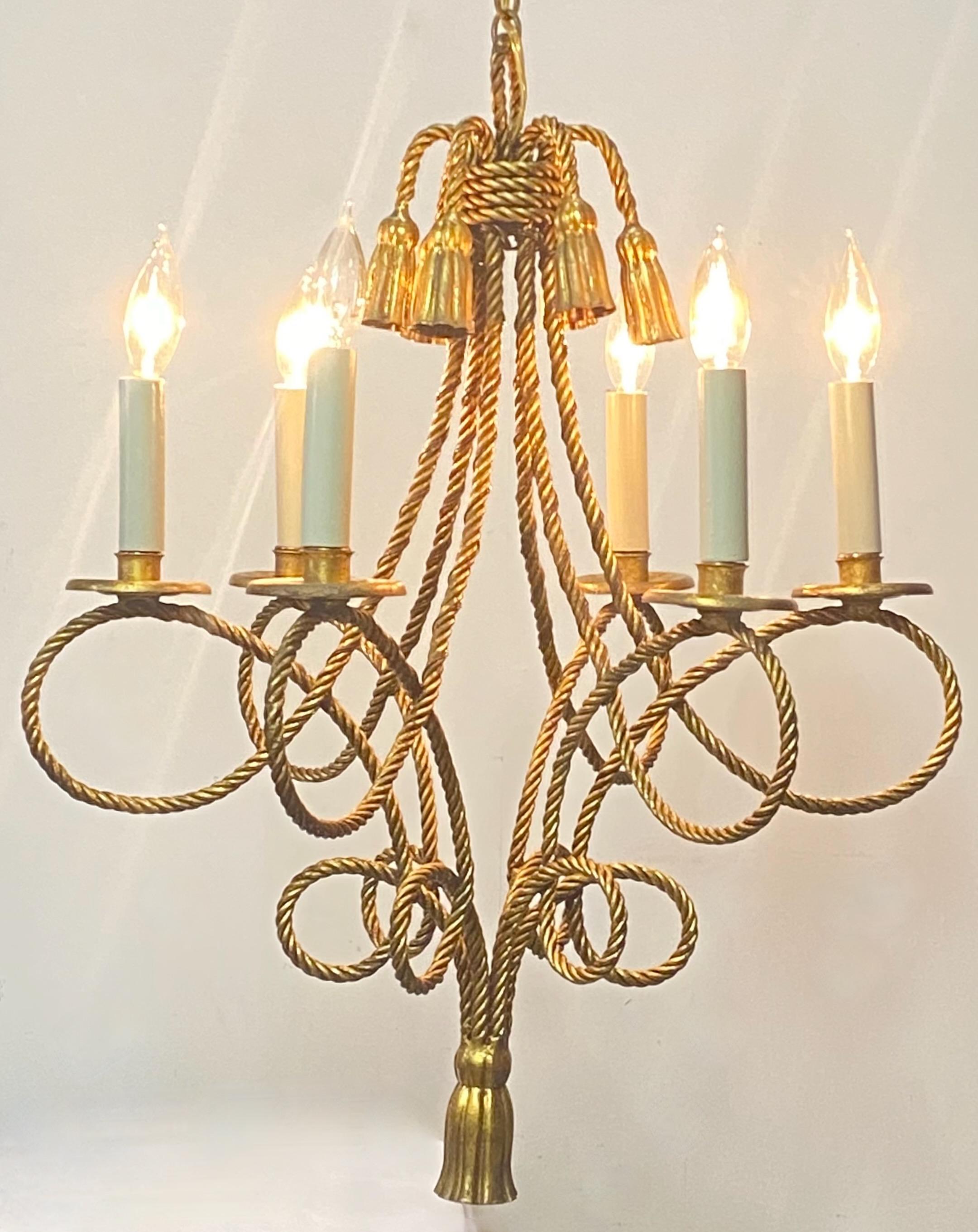 Hollywood Regency style twisted rope and tassel light fixture chandelier.
Gold painted metal frame with six arms. Recently re-wired and ready for installation.
We can adjust the length of the chain to your desired specifications.
In excellent