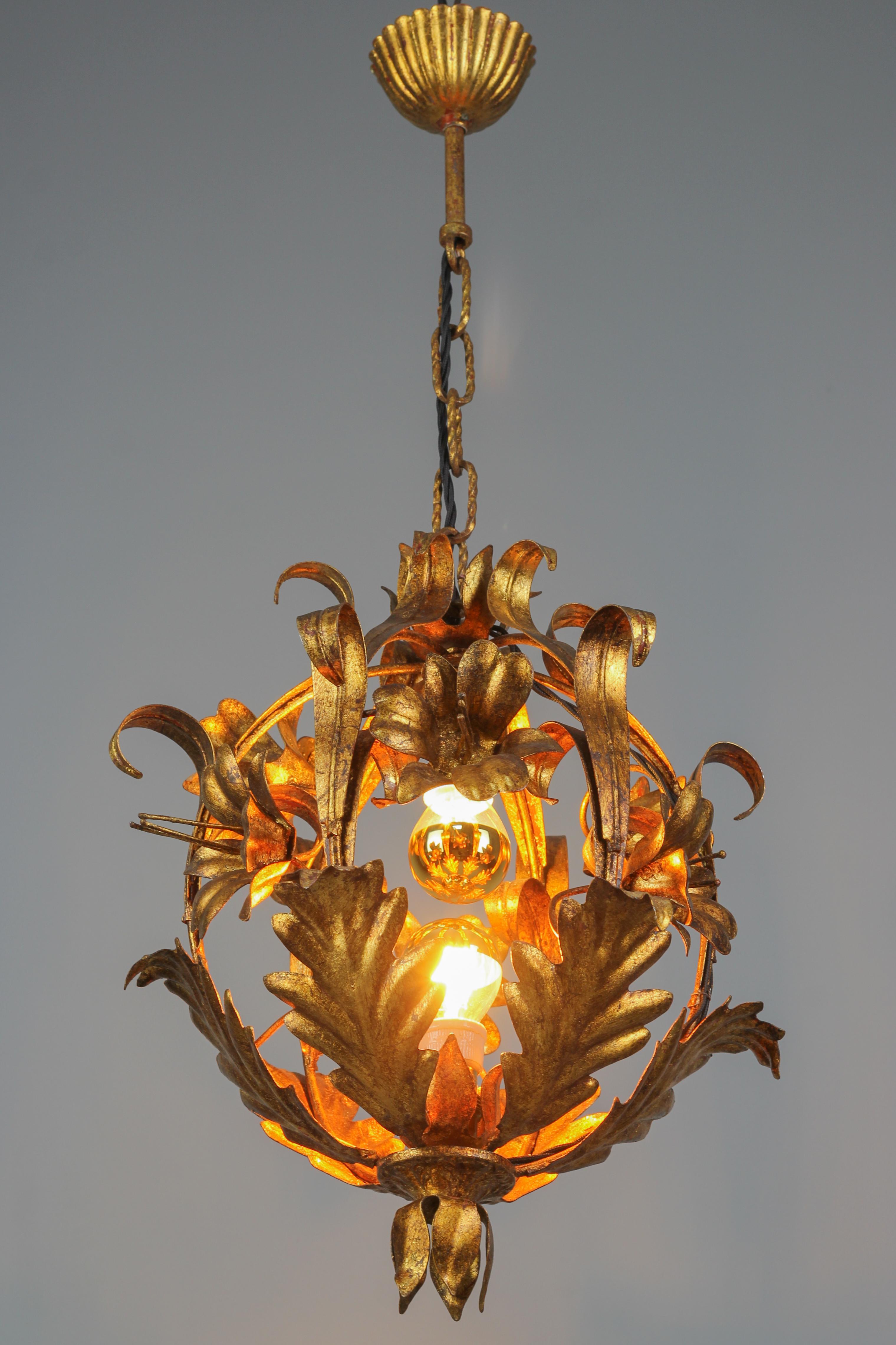 Beautiful and very unusually, circular-shaped, golden tole pendant chandelier. This adorable golden color Hollywood Regency period chandelier is decorated with lily flowers and leaves and has two sockets for E14 size light bulbs.
Italy, circa the