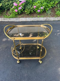 Italian Hollywood Regency Two tiered Oval Brass and Glass Bar Cart