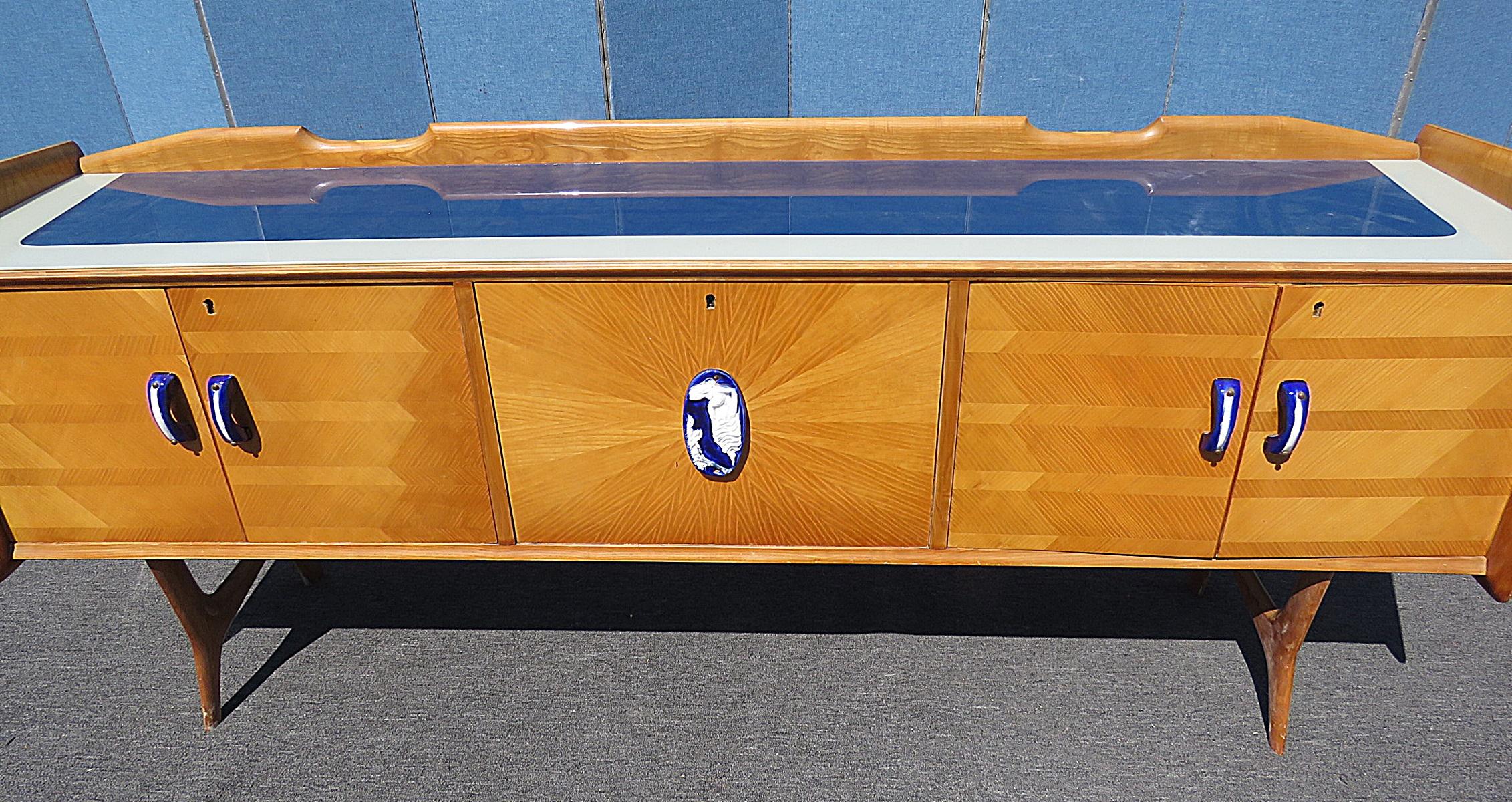 Italian Ico Parisi style glass top, inlaid credenza with cobalt handles.