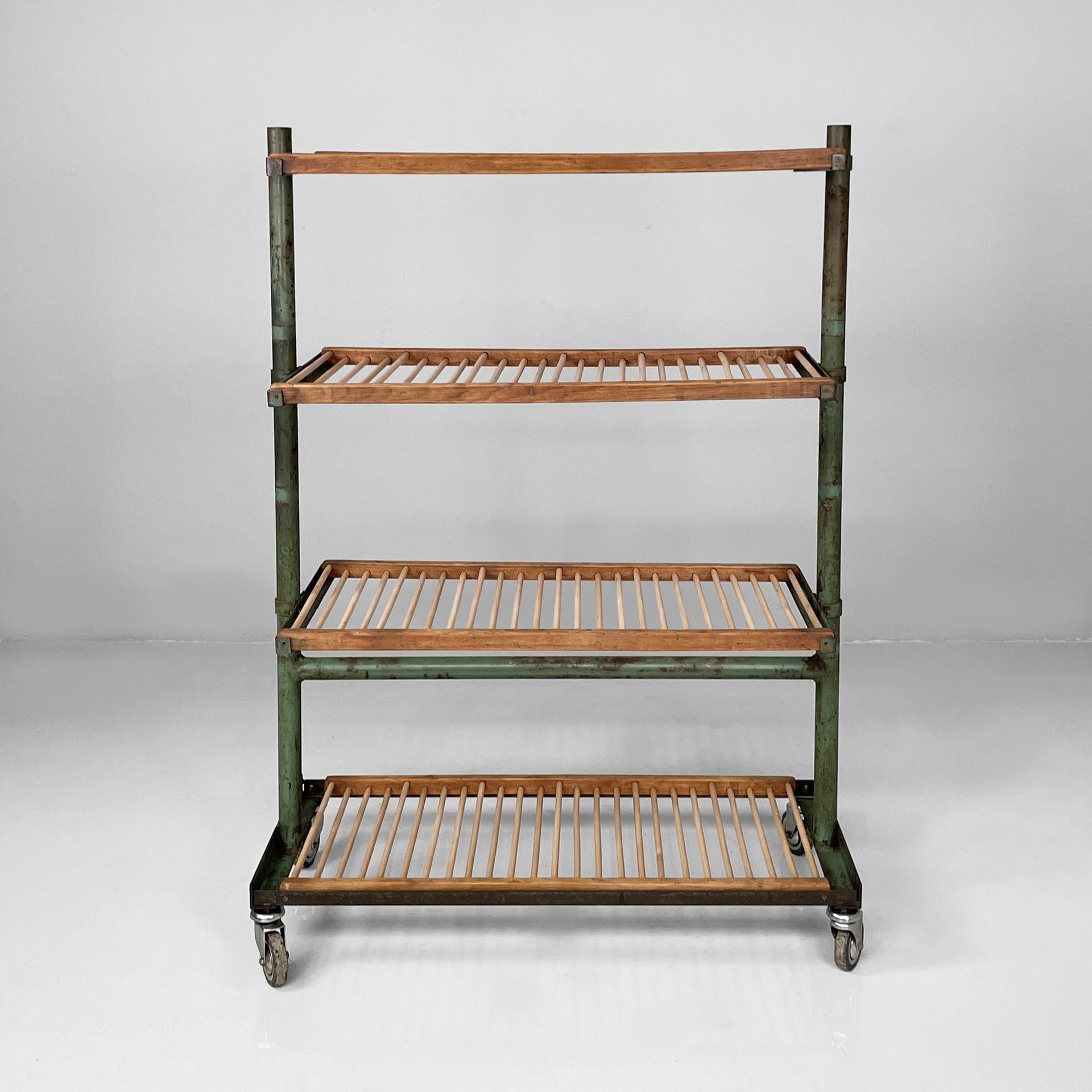 Italian industrial cart in wood and green metal, 1920s
Vintage and fantastic cart with four shelves in wood and green painted metal. Each shelf is composed of a series of round section slats, embedded in two horizontal square section slats. The