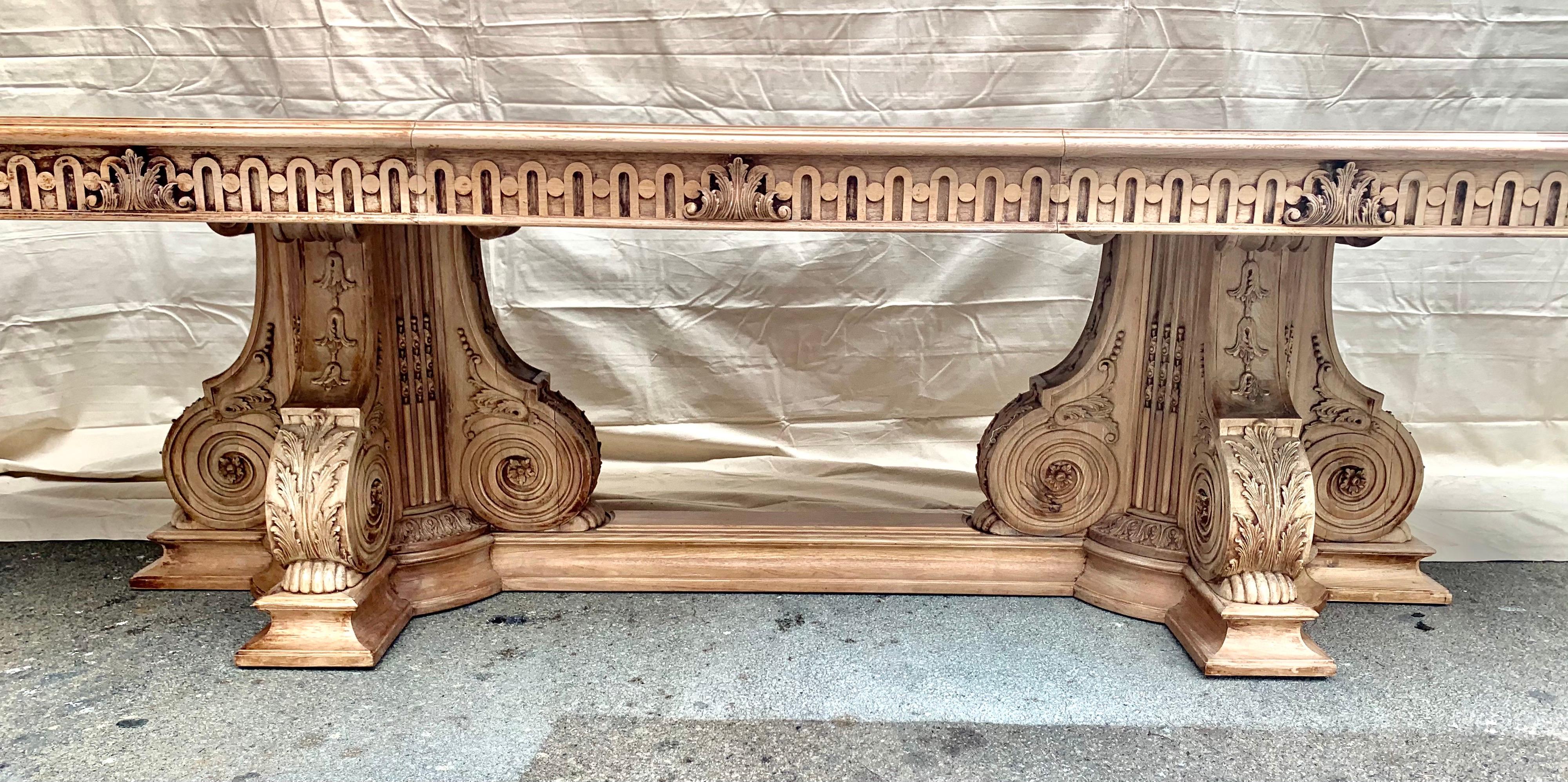 Stunning bleached walnut oval shaped dining table with black ebony inlay. The 1940s Italian bleached walnut oval shaped pedestal dining table has a bottom stretcher. A beautiful inlaid top sits on the pair of pedestals. The leaf can be removed if a