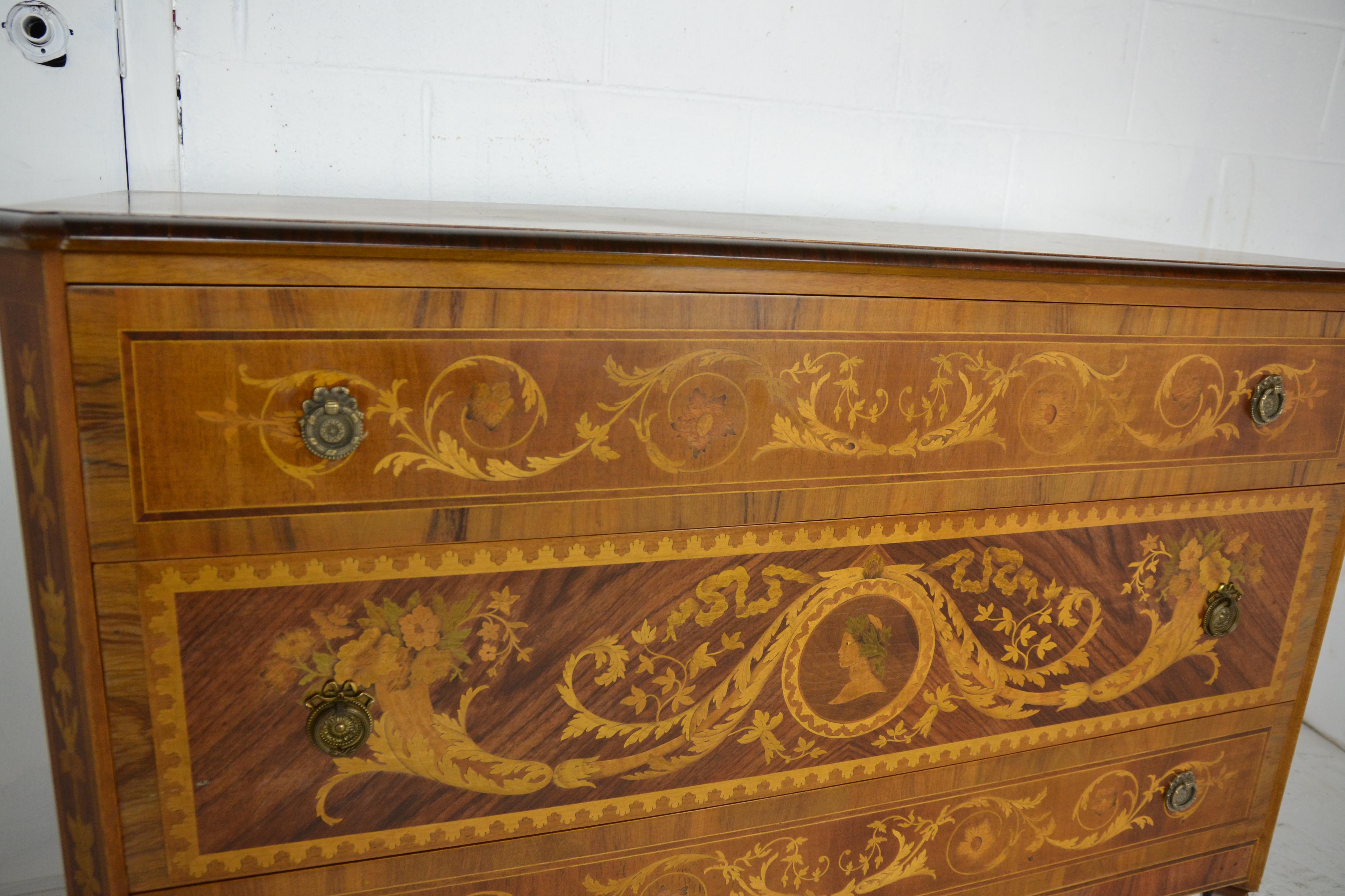 A quality made Italian 3 drawer chest of drawers with extensive inlays. Made from various woods including rosewood, olive-wood and mahogany. Top inlaid with a Peacock in a panel surrounded by Acanthus leaf and Floral displays. The center drawer