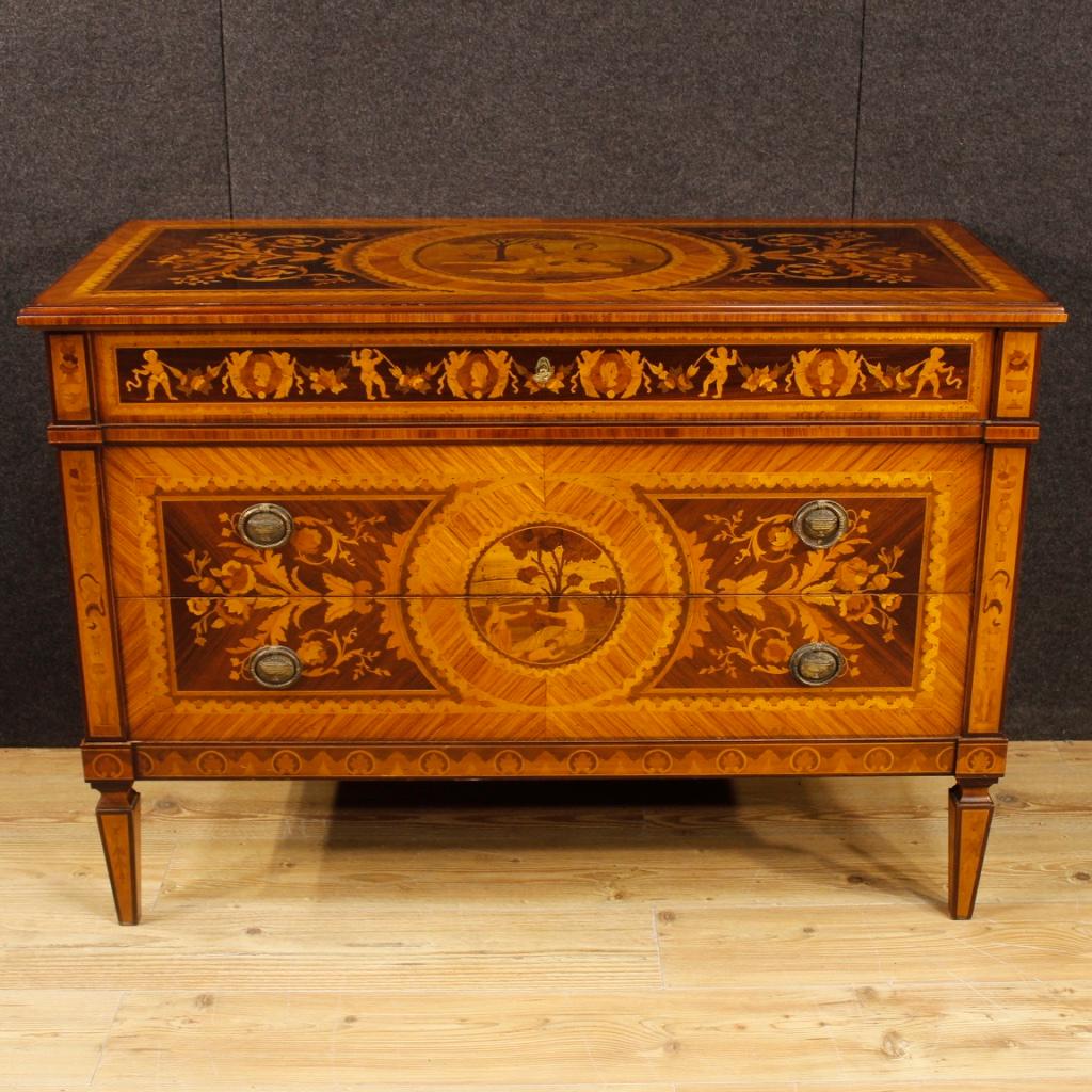 Italian dresser from the mid-20th century. Furniture in Louis XVI style richly inlaid in walnut, rosewood, mahogany, maple, tulipwood, palisander and fruitwood. Commode adorned with cherubs, flowers and scenes of neoclassical style of great quality.