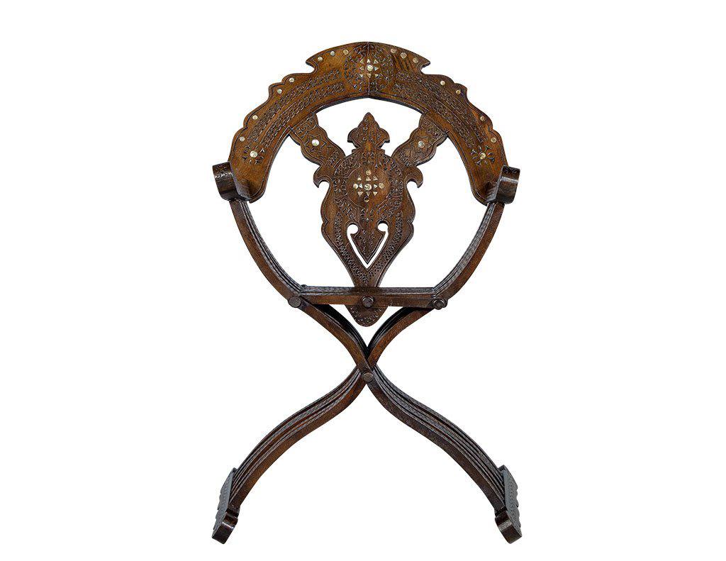 Original folding chair with finely carved detailed patterns and mother of pearl inlay.

Price includes complimentary curb side delivery to the continental USA.
