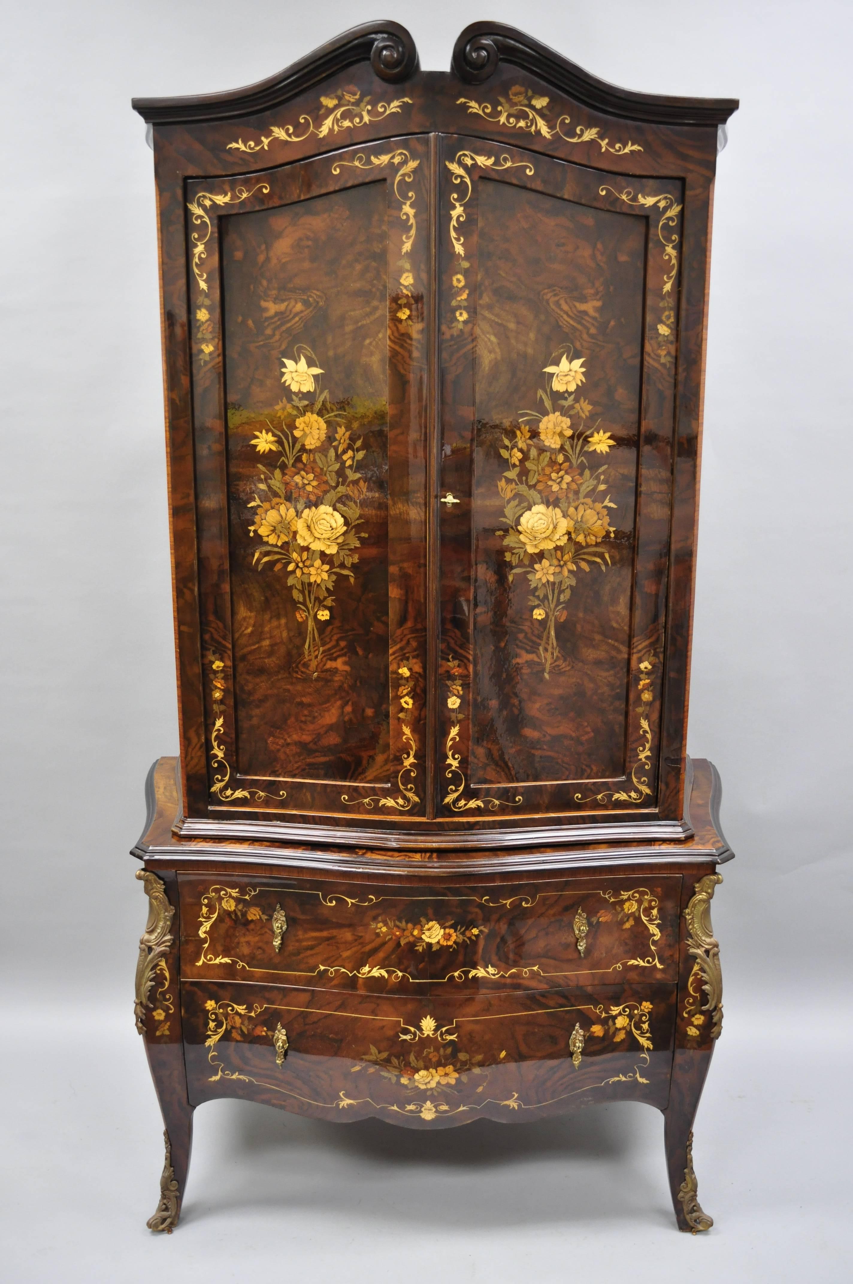 Italian inlaid bombe form armoire in the French Louis XV style by Roma Furniture in walnut briar. Armoire comes in two pieces and features beautiful floral inlay, bronze ormolu, shapely bombe form, fitted interior, cabriole legs, and stunning walnut