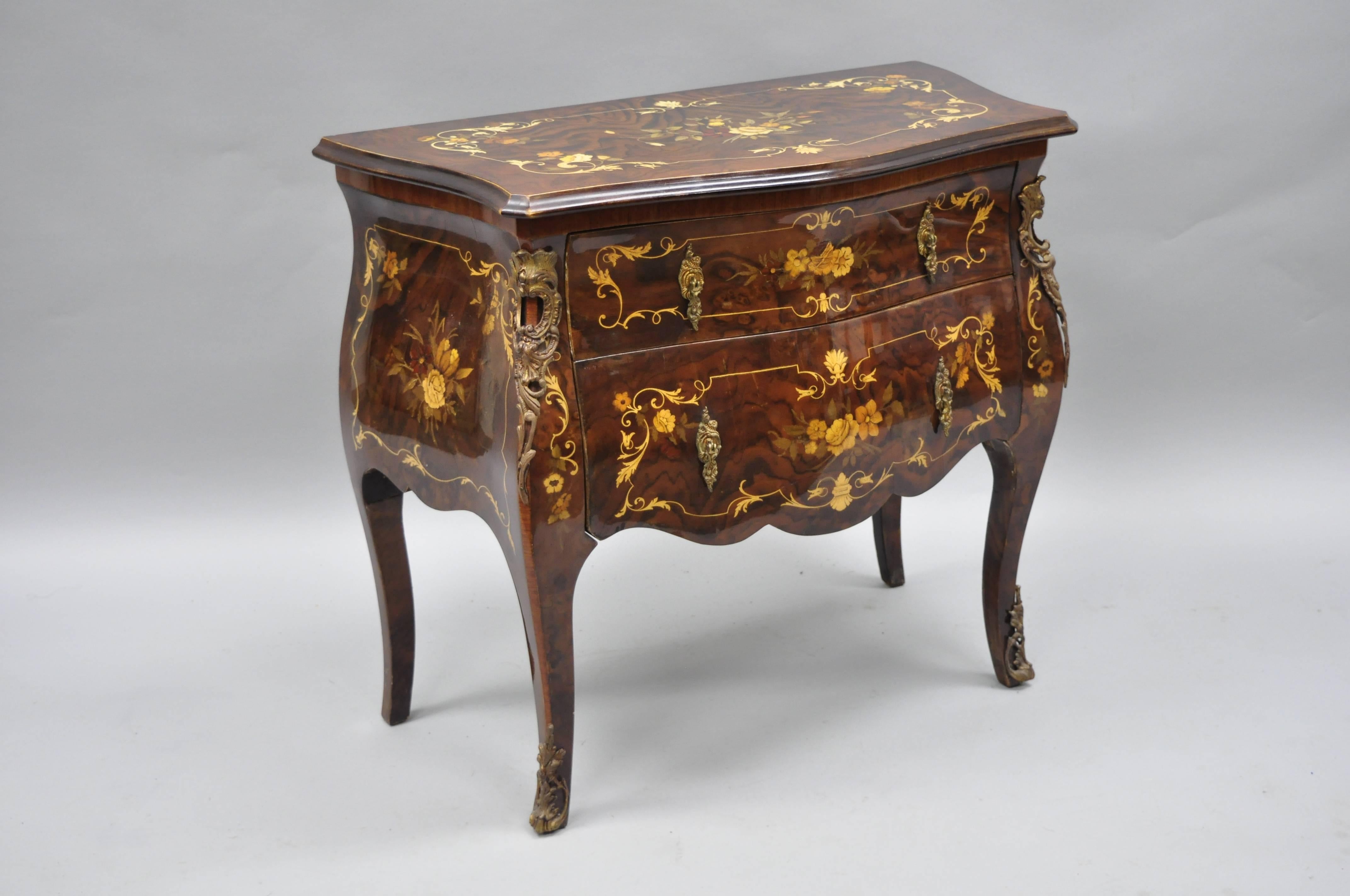 Pair of Italian Inlaid French Louis XV Style Bombe Nightstands by Roma Furniture in Walnut Briar. Nightstands feature beautiful floral inlay, bronze ormolu, shapely bombe form, two dovetailed drawers, cabriole legs, and stunning walnut briar wood