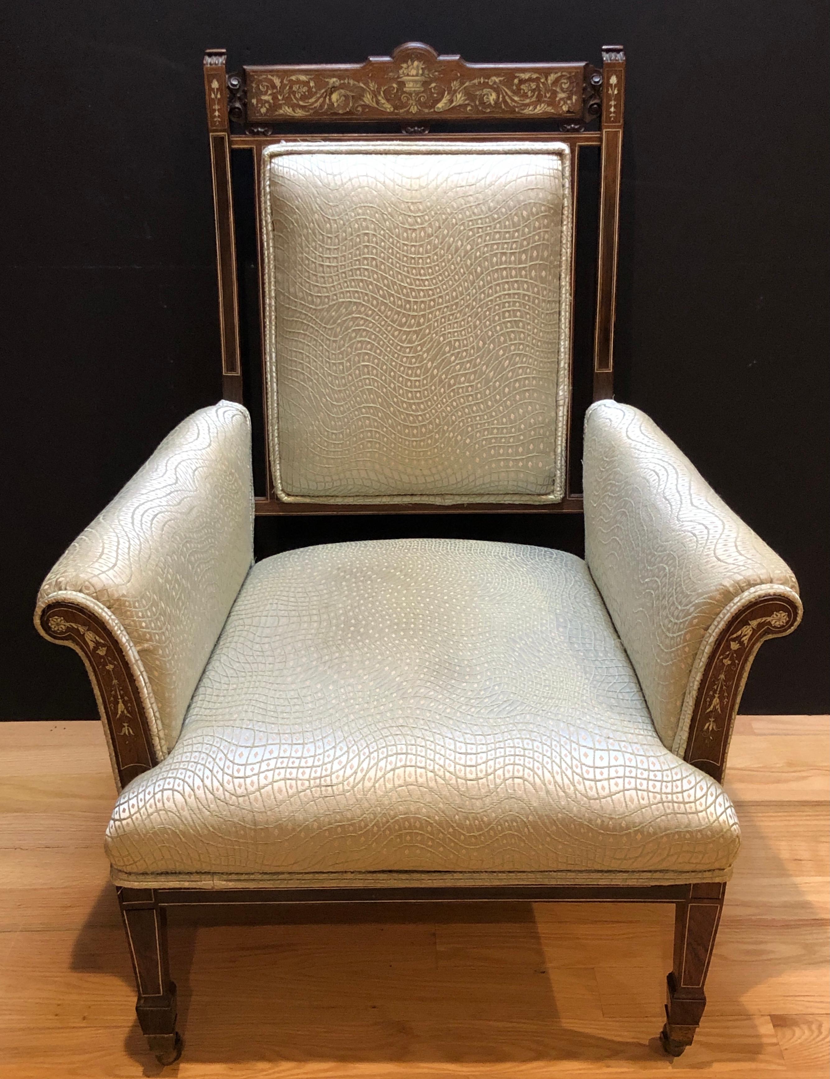 Inlaid marquetry bone and rosewood library chair. Top back stretcher with inlay of fruit filled urn and foliate scrolls ending with a mythological dolphin. Arm fronts with inlay of rosette and vine foliate. Can be used a a great side chair.