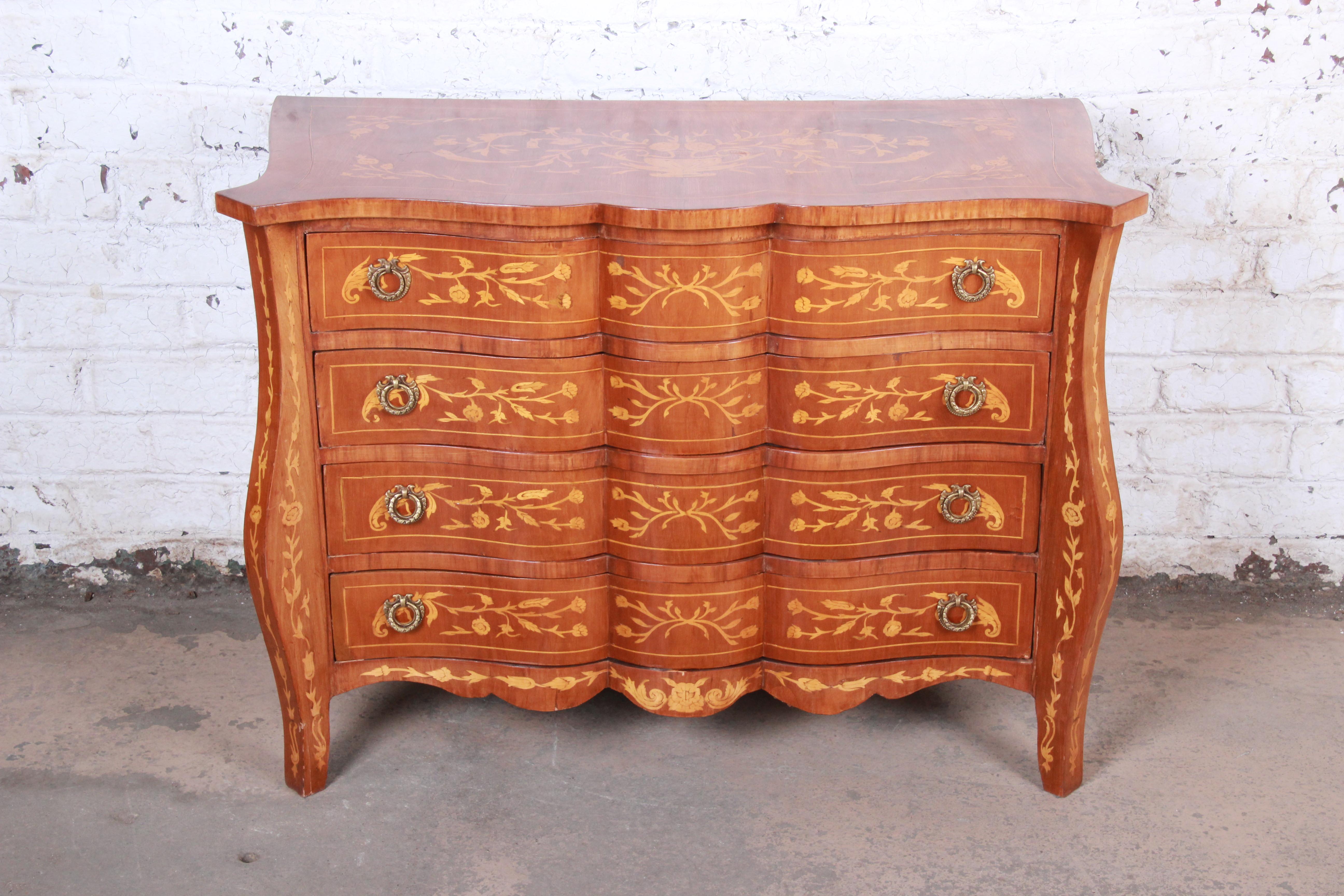 An exceptional Italian inlaid marquetry mahogany four-drawer bachelor chest of drawers or commode

Italy, circa 1930s

Mahogany, satinwood inlay and original brass hardware

Measures: 43.25