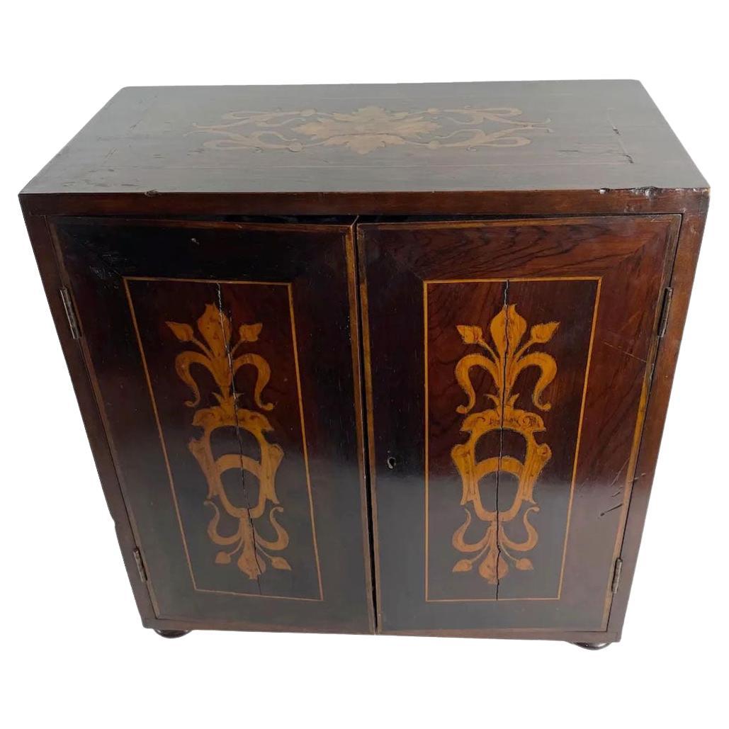 Italian inlaid wood marquetry collectors cabinet with multiple drawers and lion head pull. Circa 1830s.