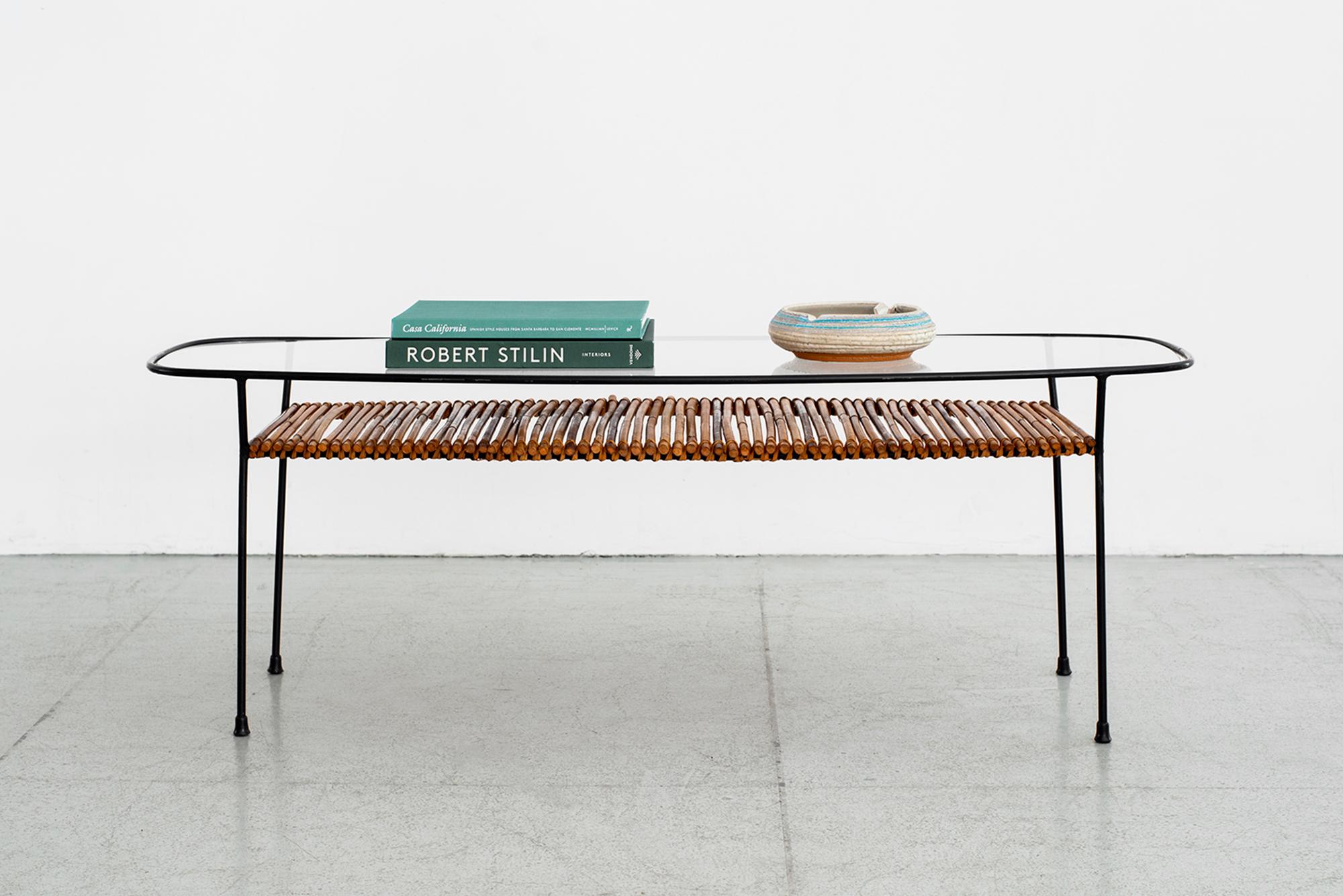 1960s Italian iron and bamboo coffee table with glass top, iron frame and bamboo shelf.
Oblong shape, and impressive in scale.
