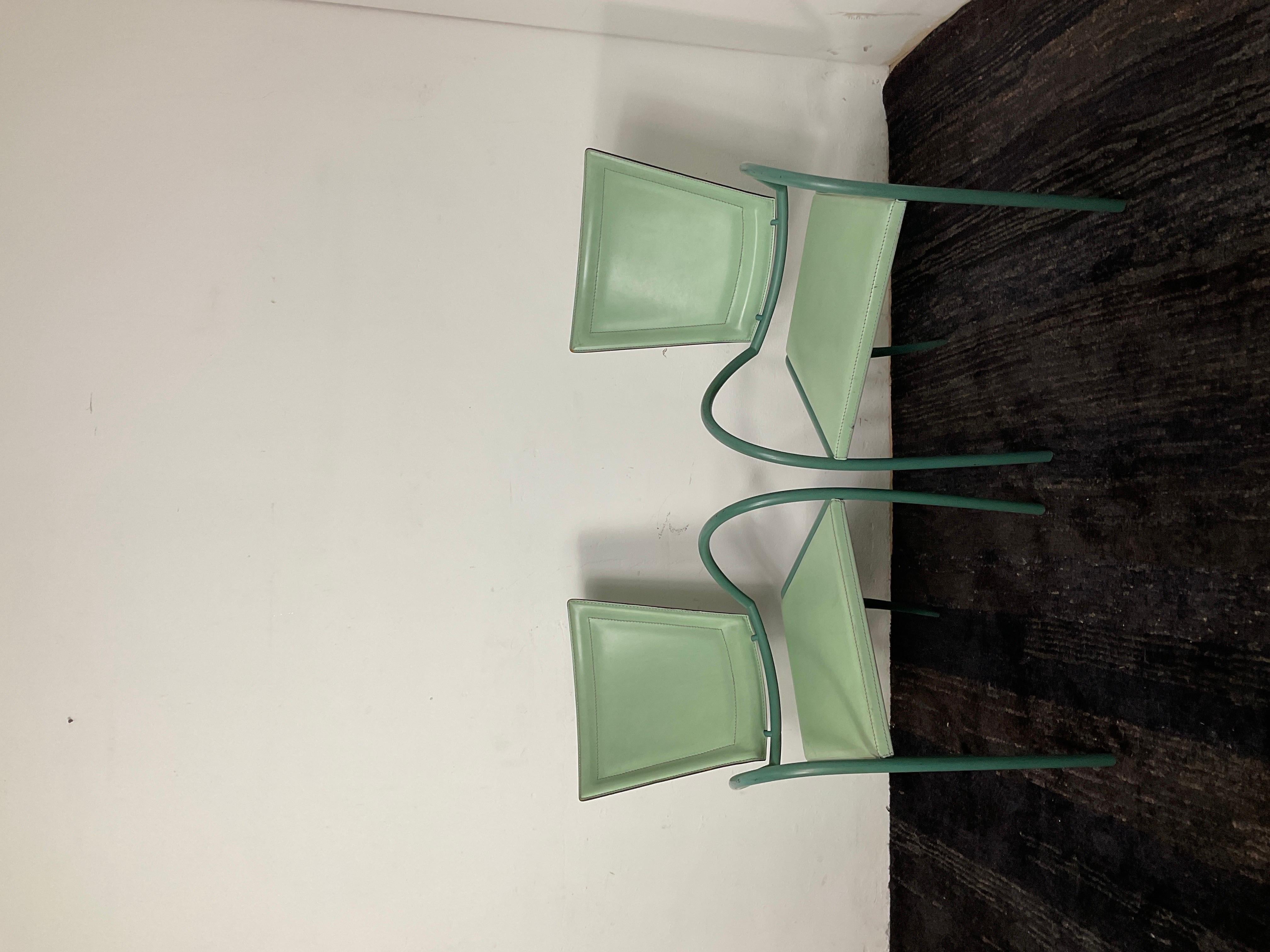 
Stunning pair of Italian iron and leather chairs by Sawaya & Moroni, made in Milan. These Italian Jacques Adnet style side chairs are in a fabulous green iron and green stitched leather and retain their original labels. The curvature of the iron is