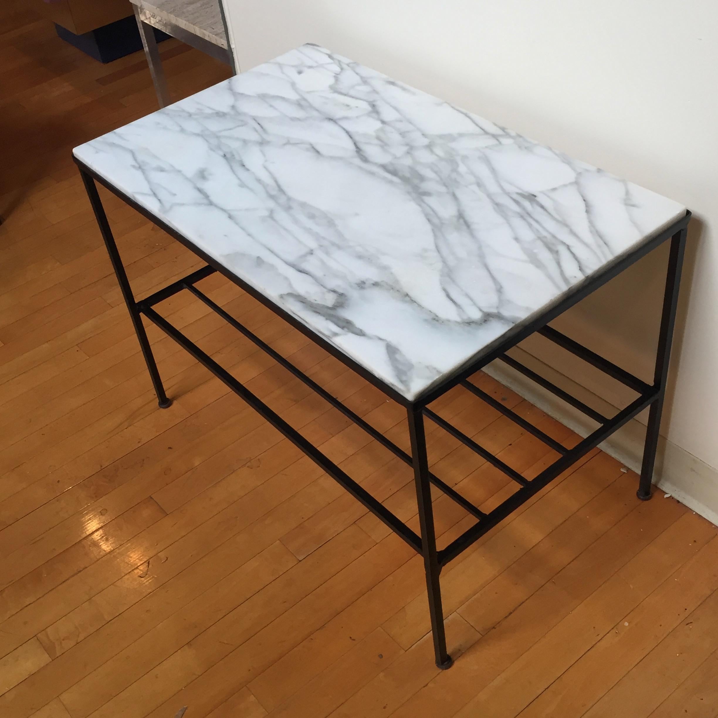 This versatile two-tier marble table has a Carrara marble top and wrought iron shelf making it a versatile piece for almost any room in the house. Legs have original levelers.

 