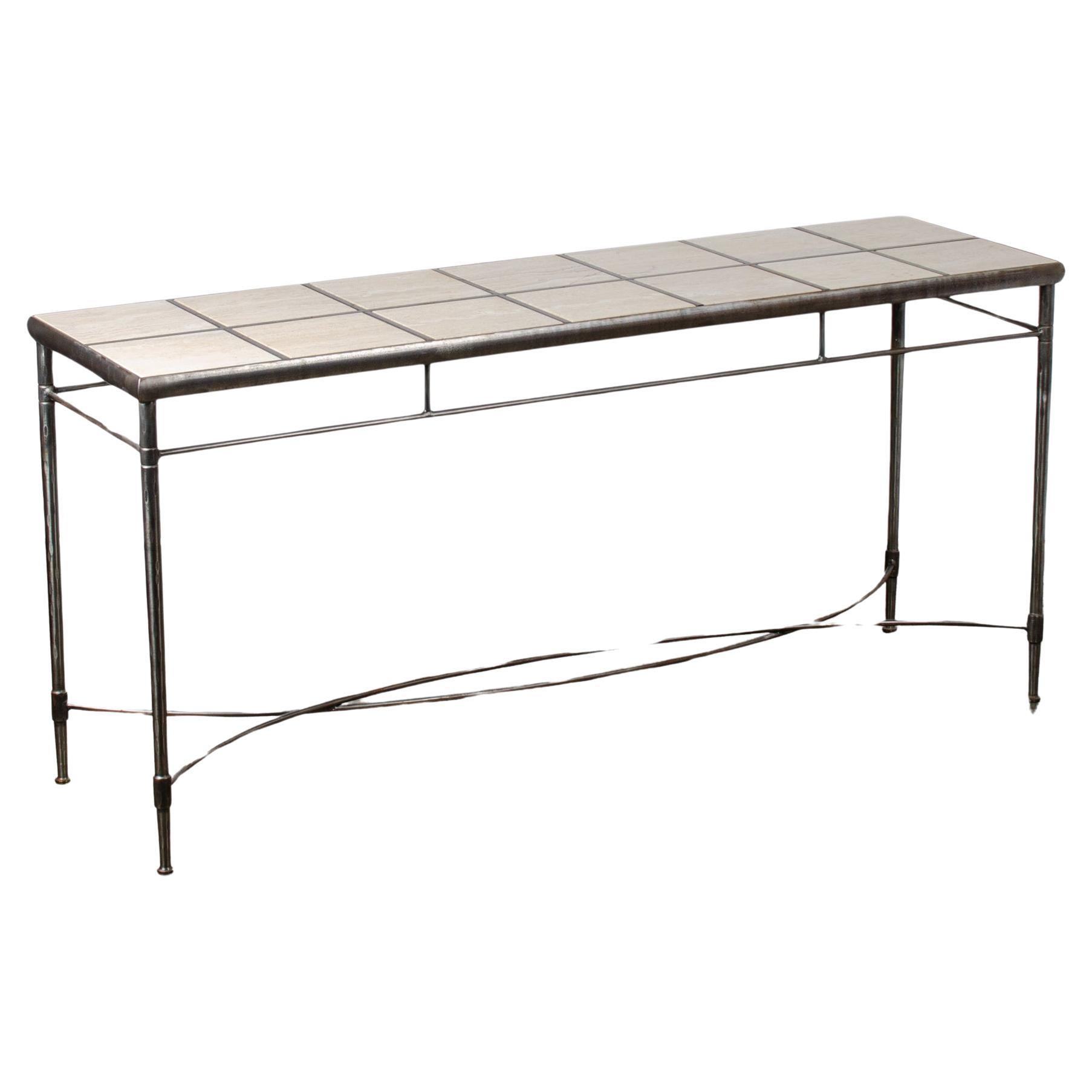 A hammered and polished iron and travertine tile top console table made in Italy circa the 1980s. 

Fourteen thick ¾ inch travertine tiles drop into recesses atop a hand-hammered and polished iron frame.  Stamped “Made Italy” on the curved stretcher