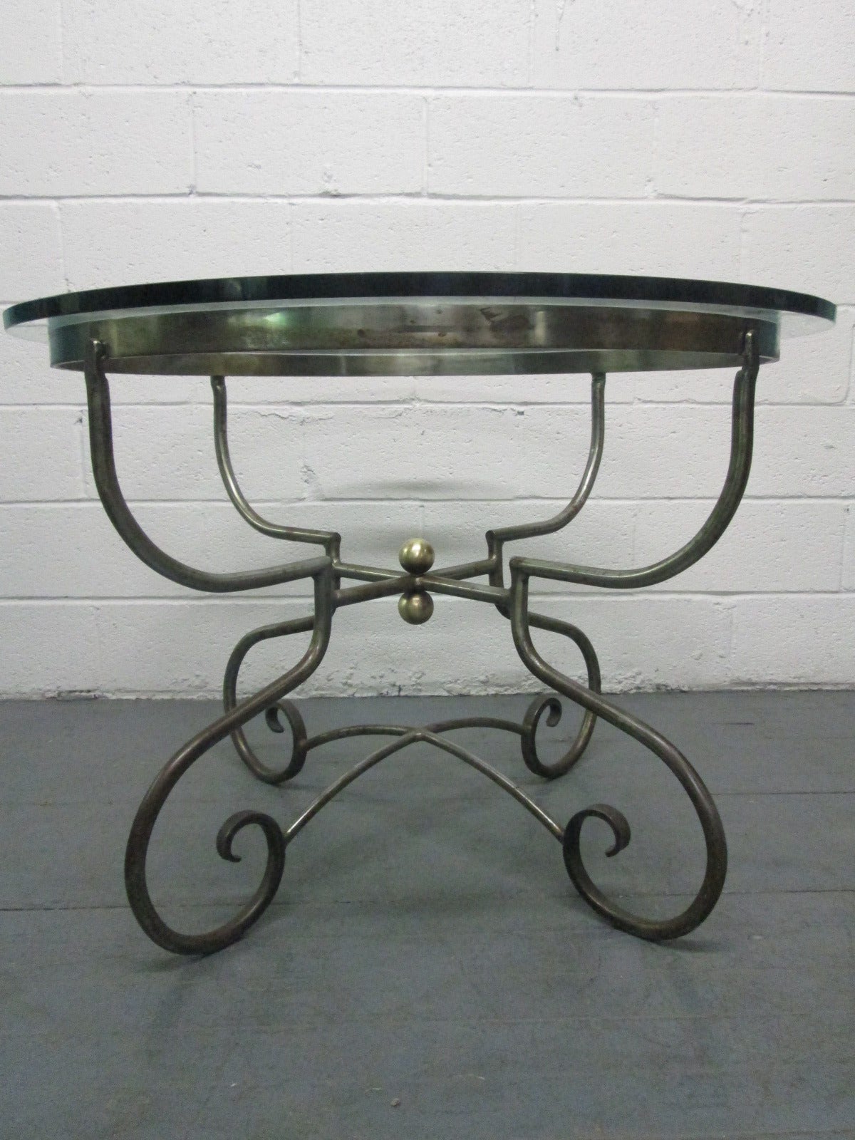 Italian wrought iron center table. Has round bronze accents. Gueridon table, occasional table.