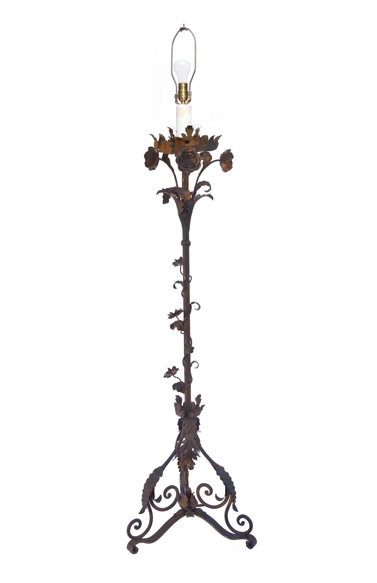 Hand crafted vintage Italian wrought iron floor lamp, Stunning craftsmanship with lots of ornate detail. The gilt finish has been aged with oxidizers to add a natural rust patina over the original gilt surface. 
Re-wired with solid brass sockets &
