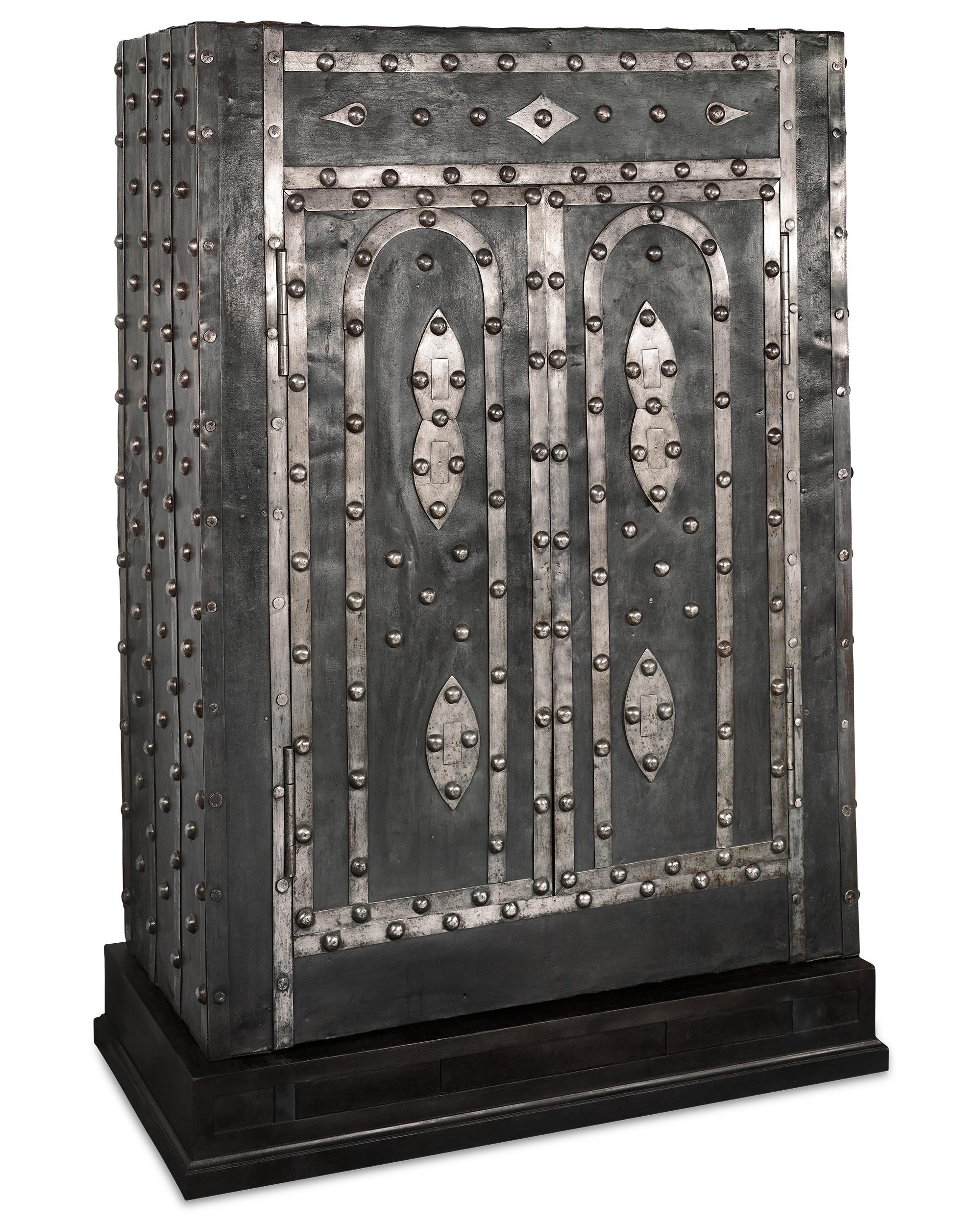 A marvel of mechanical complexity and exceptional craftsmanship, this monumental Italian safe was one of the most secure means by which valuables could be stored in the 19th century. The iron structure is covered with thick iron plates, polished