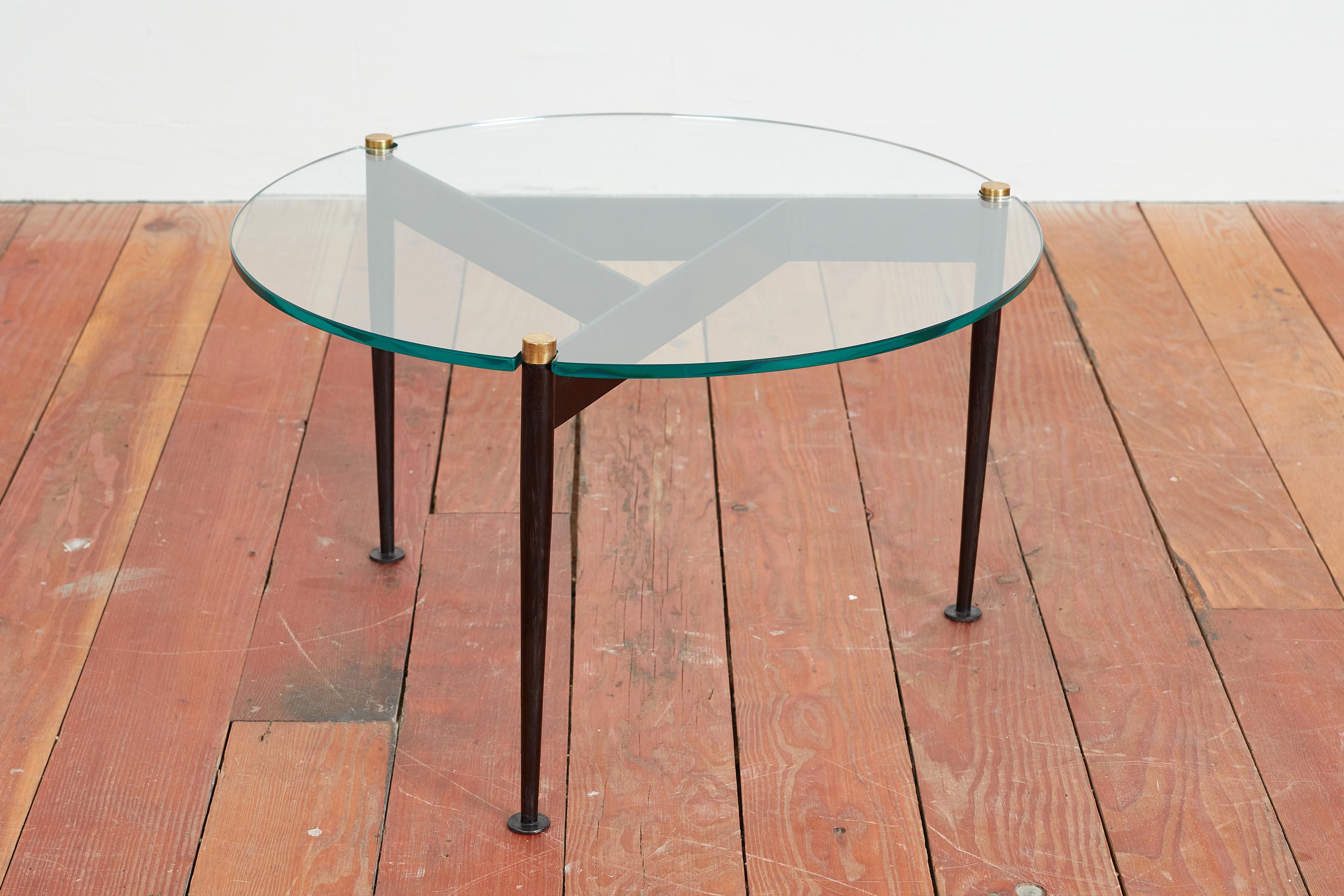1950's Italian side table with 3 angular legs with brass detail and glass top. 
Simple design at its best! 